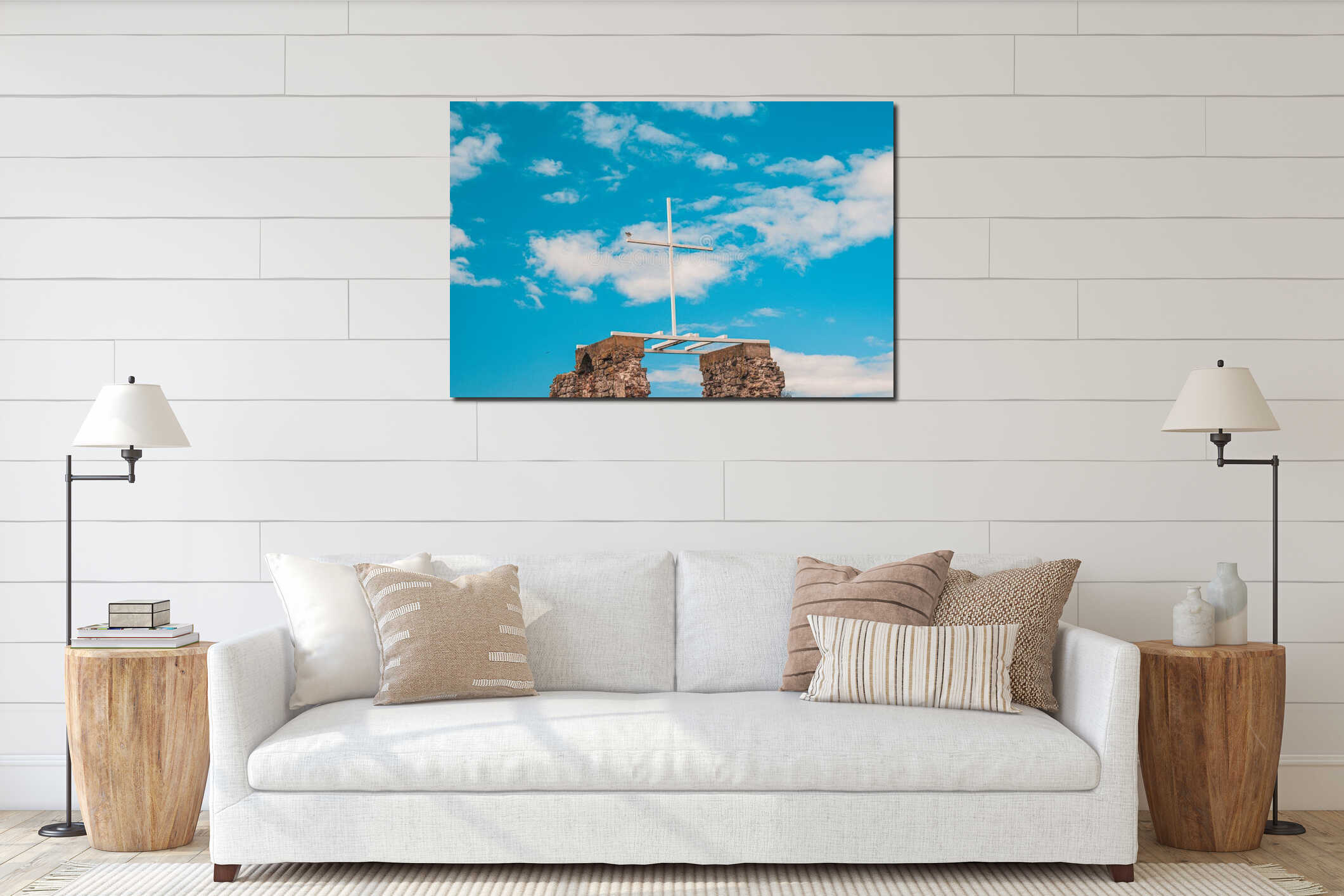 A white wooden cross against a blue sky with clouds, a seagull sits on the edge interior mockup