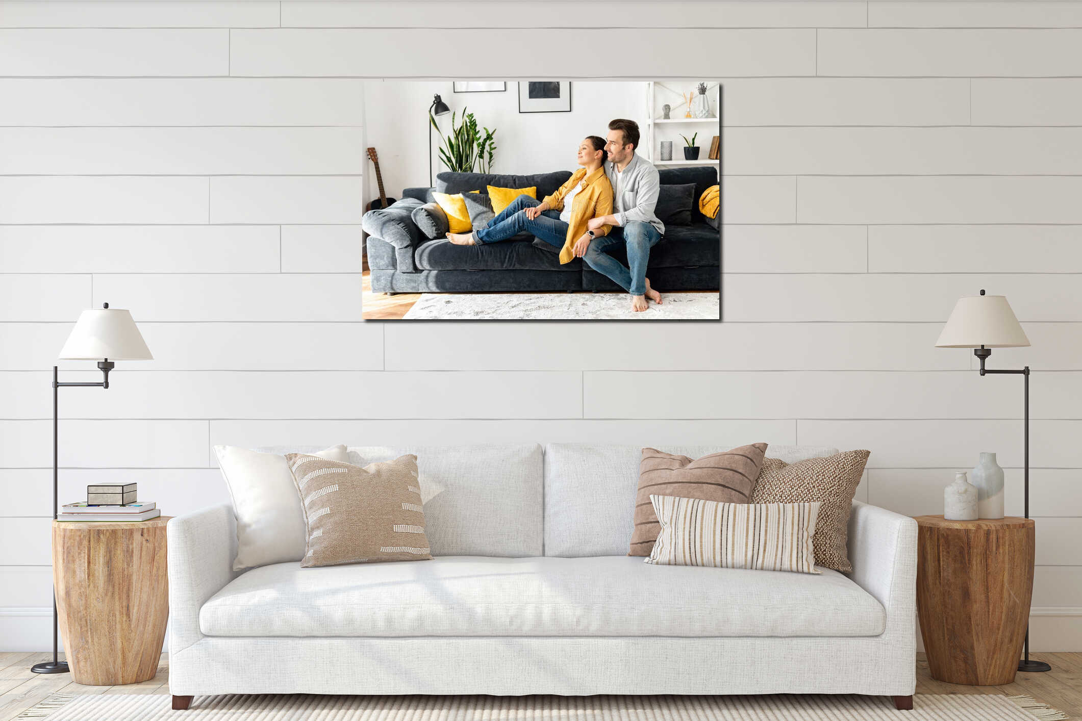 Concept of support and caring in marriage. Gentle and lovely mid-aged couple in love sitting in embrace on the interior mockup