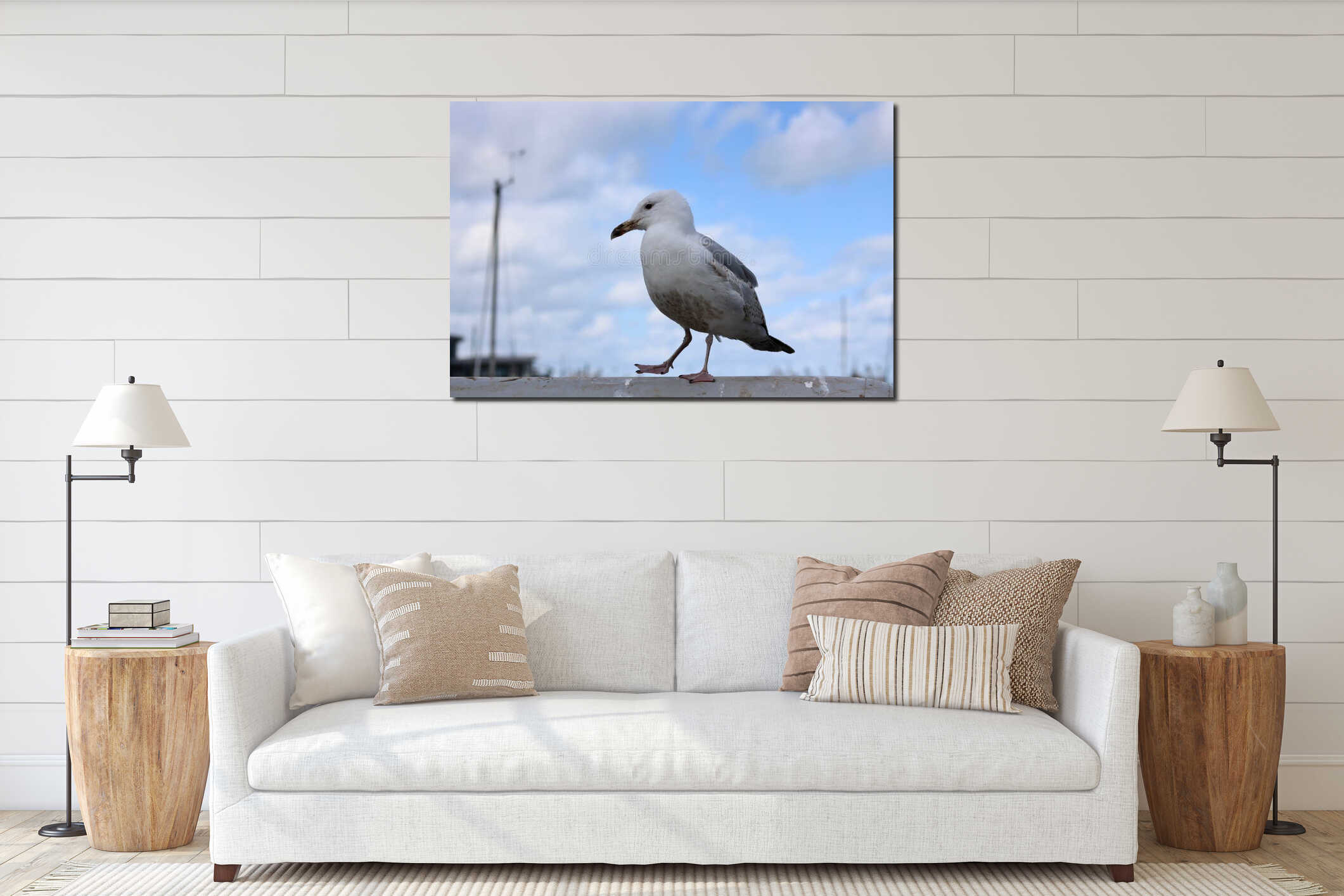 Seagull standing on harbourside wall with mast in distance against blue sky interior mockup