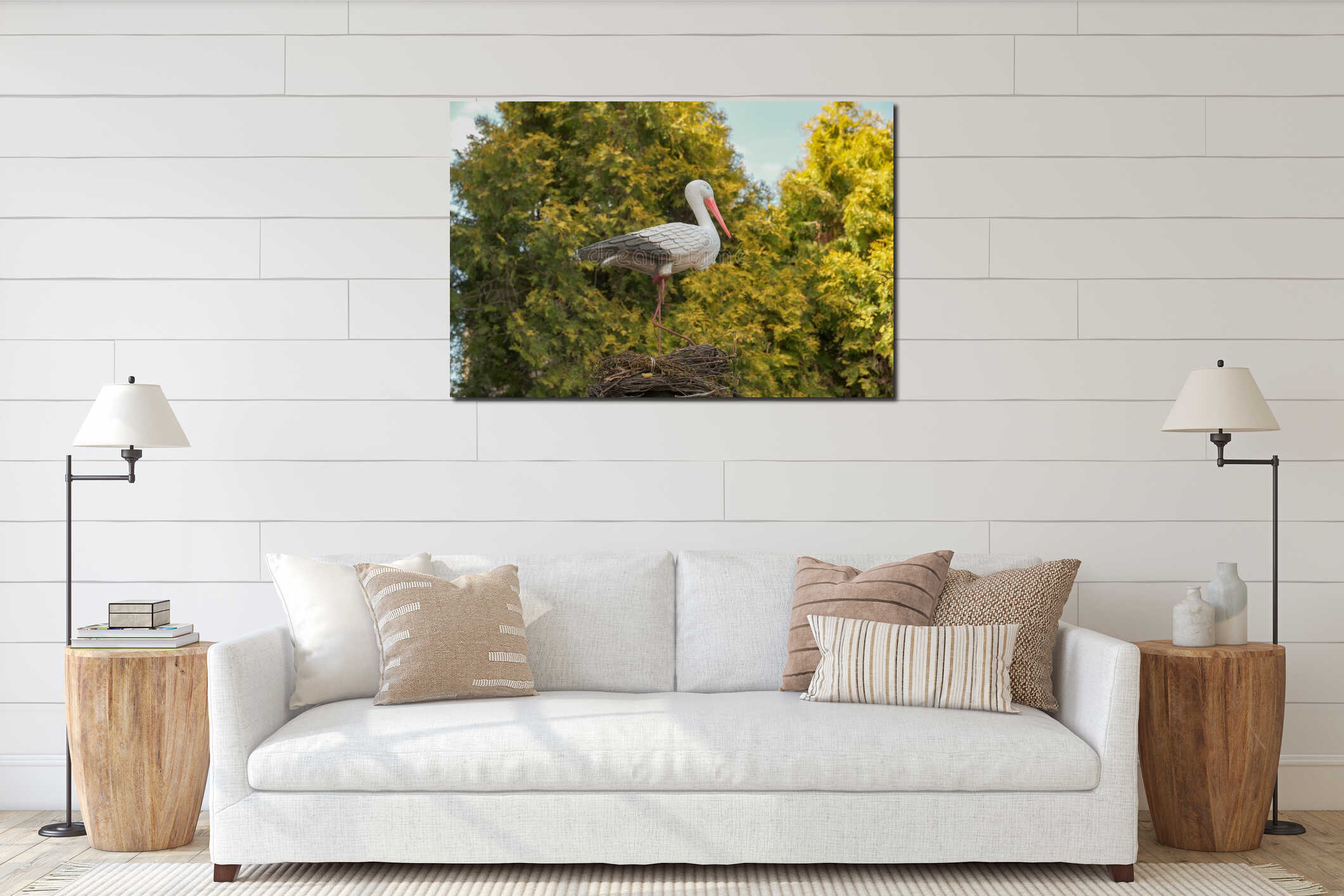 Artificial stork in the garden. Statues of stork. Plastic bird stork in grass. Decoration element . artificial stork in the nest interior mockup