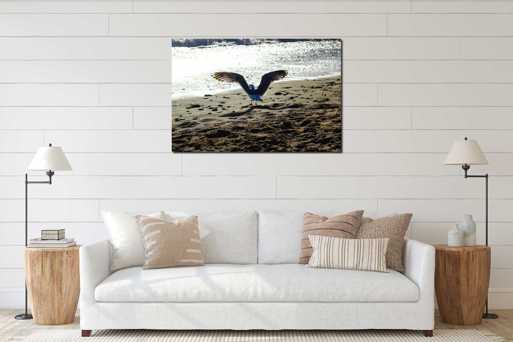 A white and brown seagull standing on the beach near the ocean spreading its wings at Marina Park Beach in Ventura California interior mockup