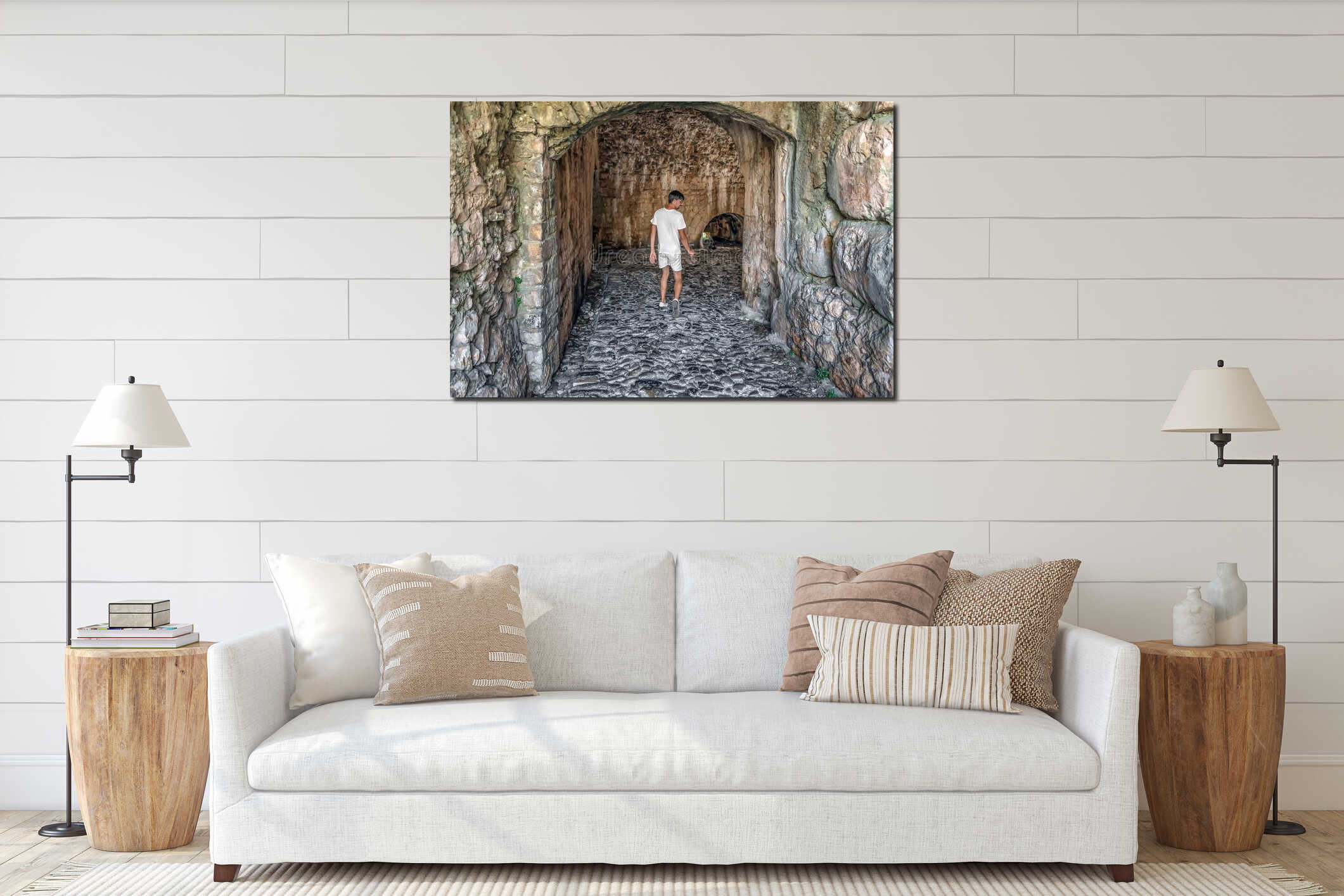 A man enters an ancient arched tunnel in Rozafa Castle, Albania interior mockup