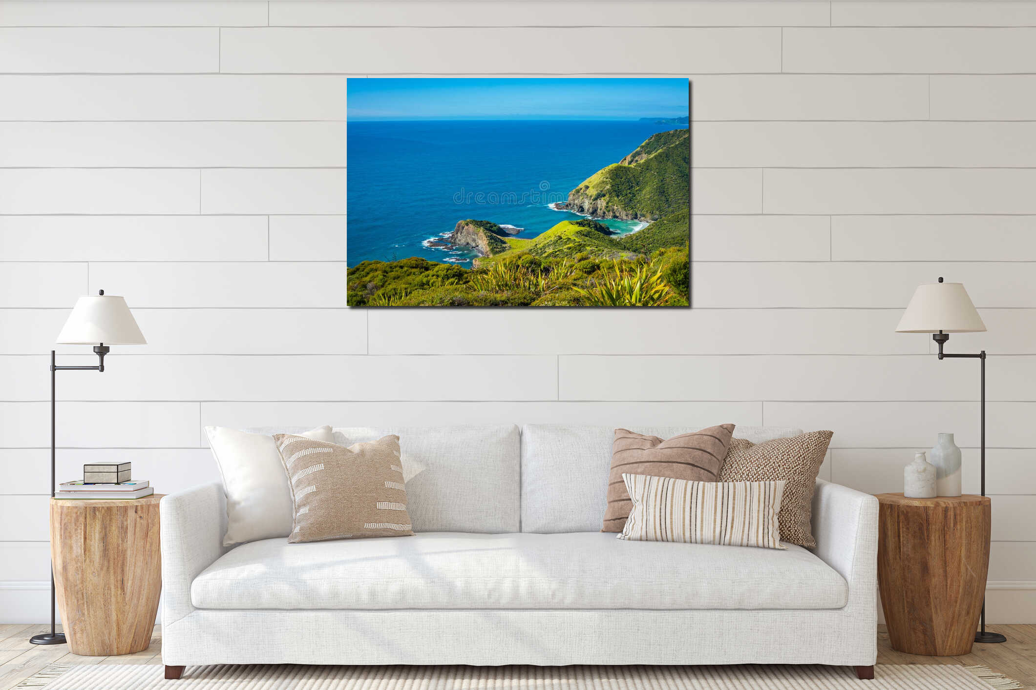 Looking down at a stunning rocky coastline of Cape Reinga. Turquoise water of Tasman Sea under clear blue sky, quiet interior mockup