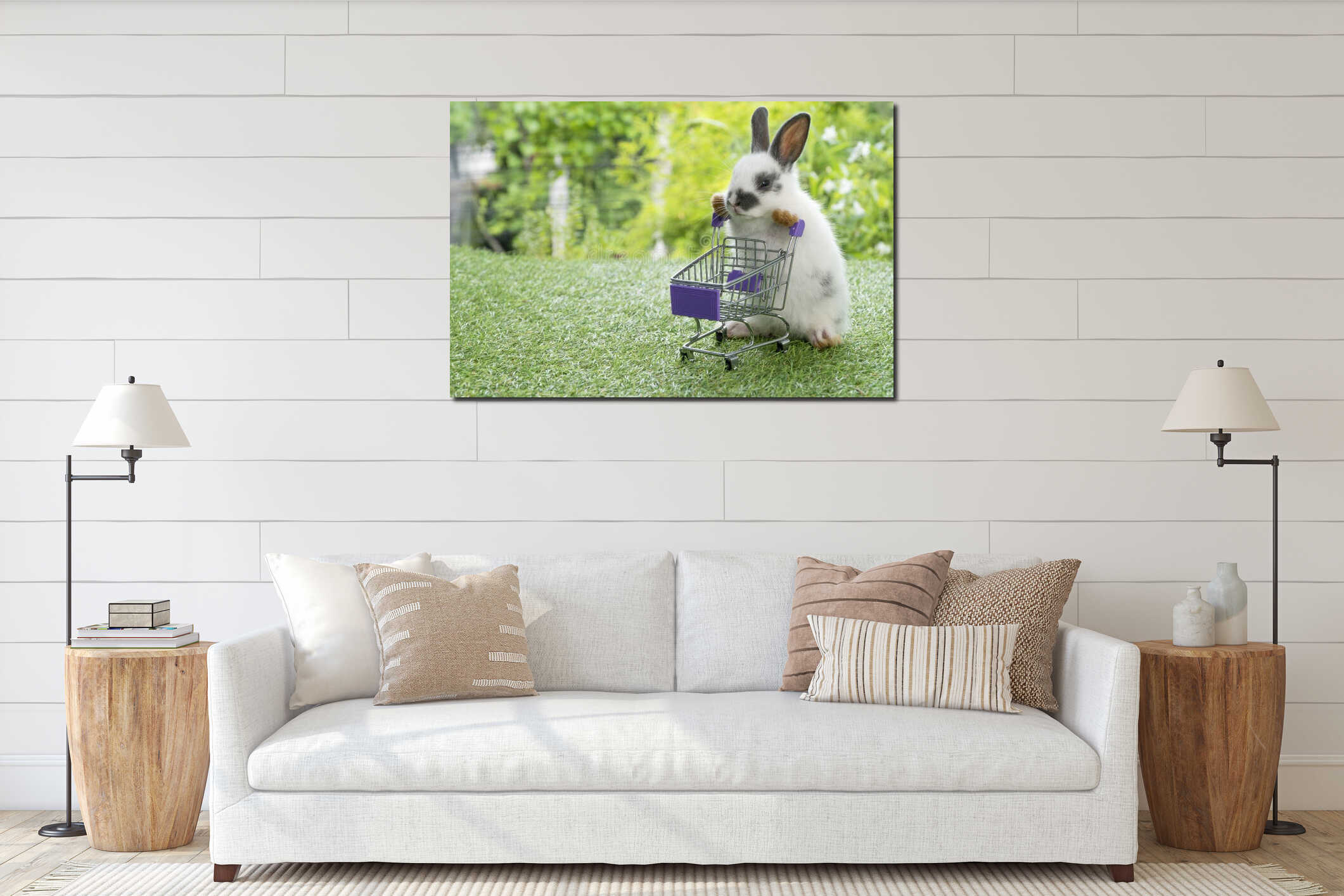 Adorable baby rabbit white black pushing empty purple shopping basket cart while walking on green grass over nature background. interior mockup