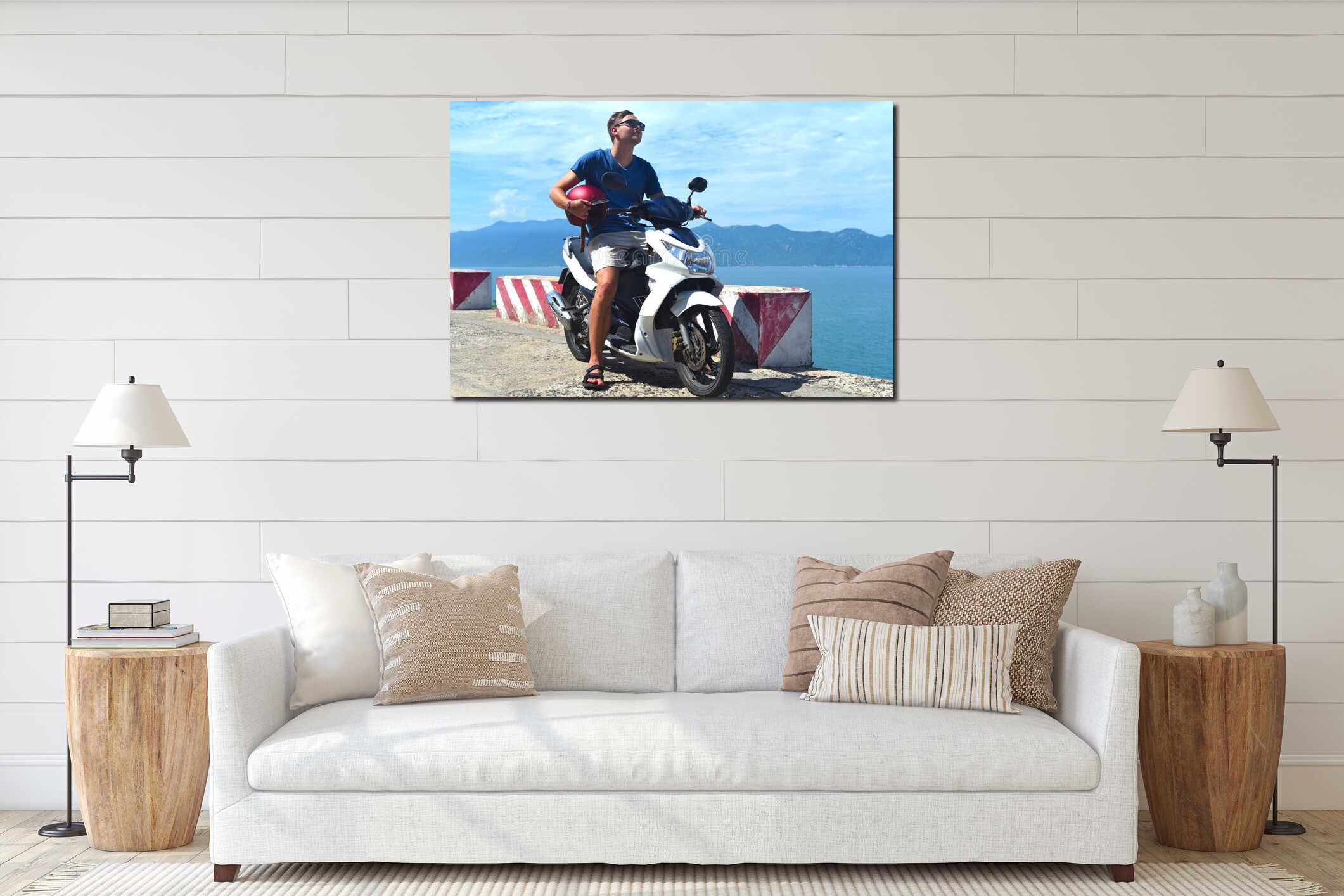 Young man motorbike driver sitting and holding helmet against south south china sea in vietnam interior mockup