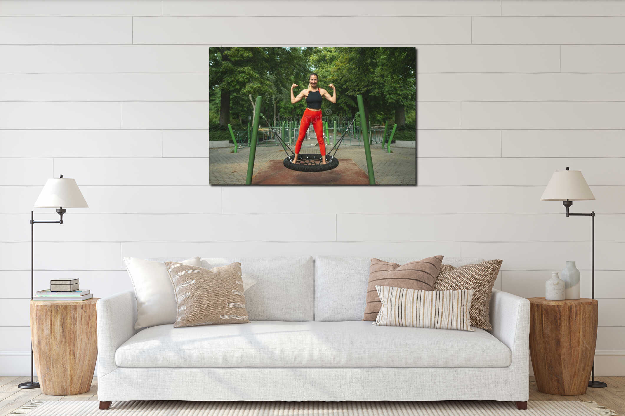 Athletic beautiful middle-aged woman in black and red fitness clothes posing joyfully on the sports ground interior mockup