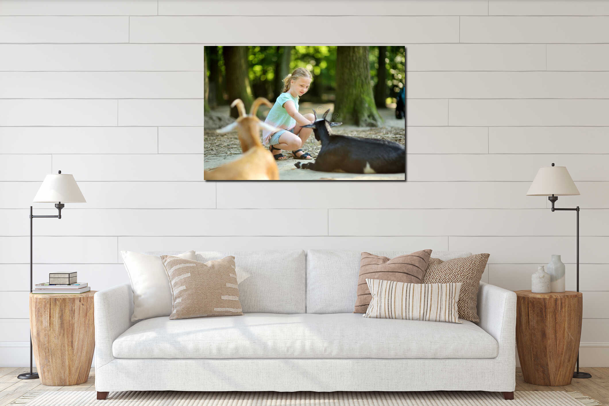 Young girl feeding goats at a zoo on summer day. Children watching livestock on a farm interior mockup
