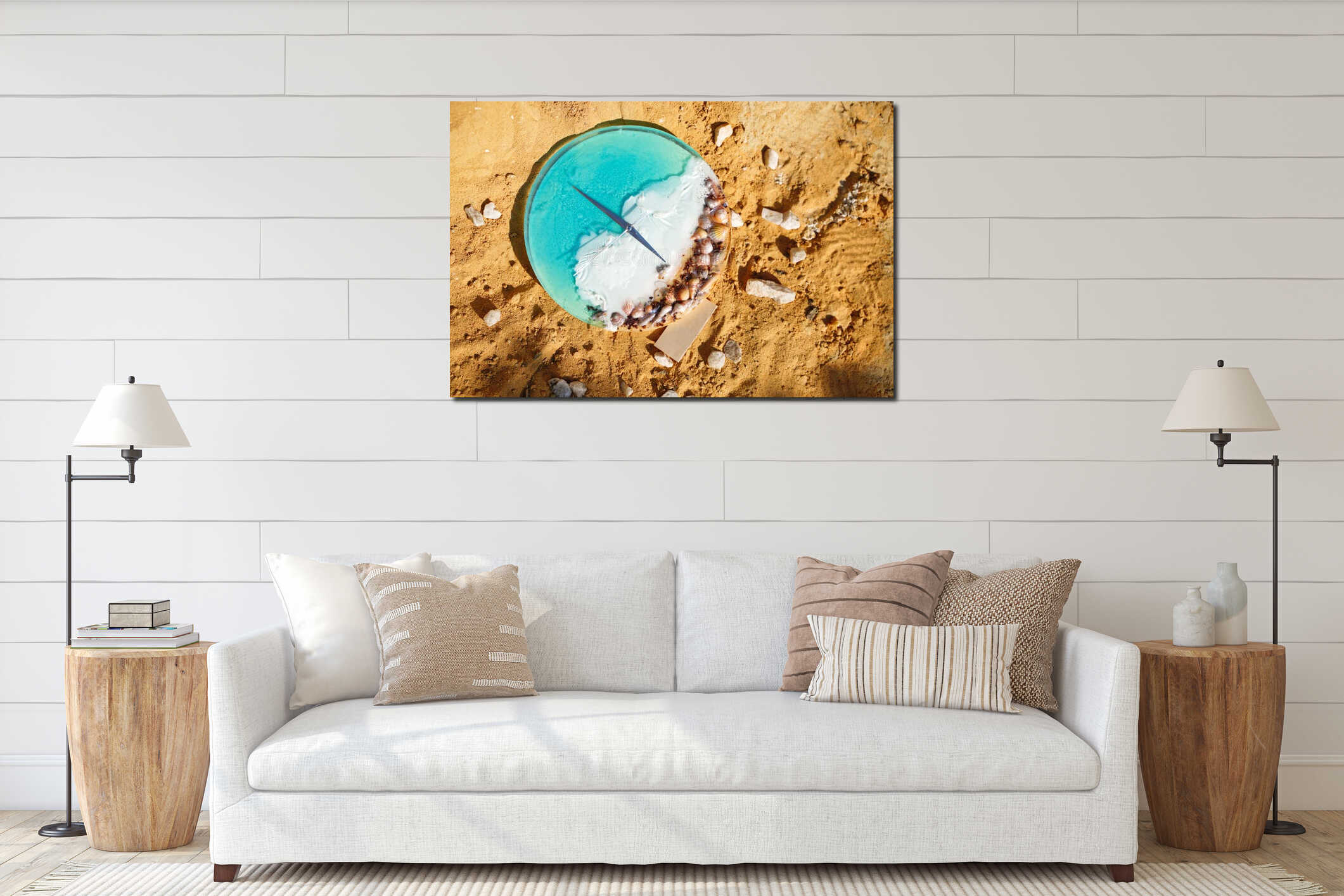 An alarm clock with seashells sitting on the sand with water, vacation time. Beach Time interior mockup