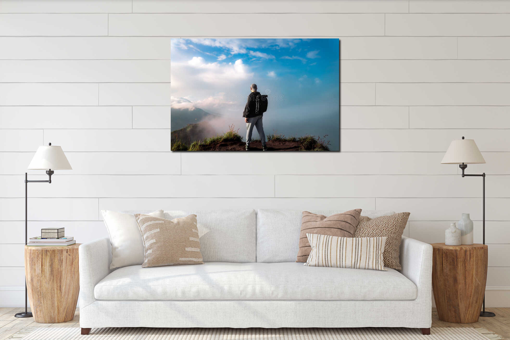 Scenic view of a male person standing on top of a volcanic mountain with clouds in front of him interior mockup