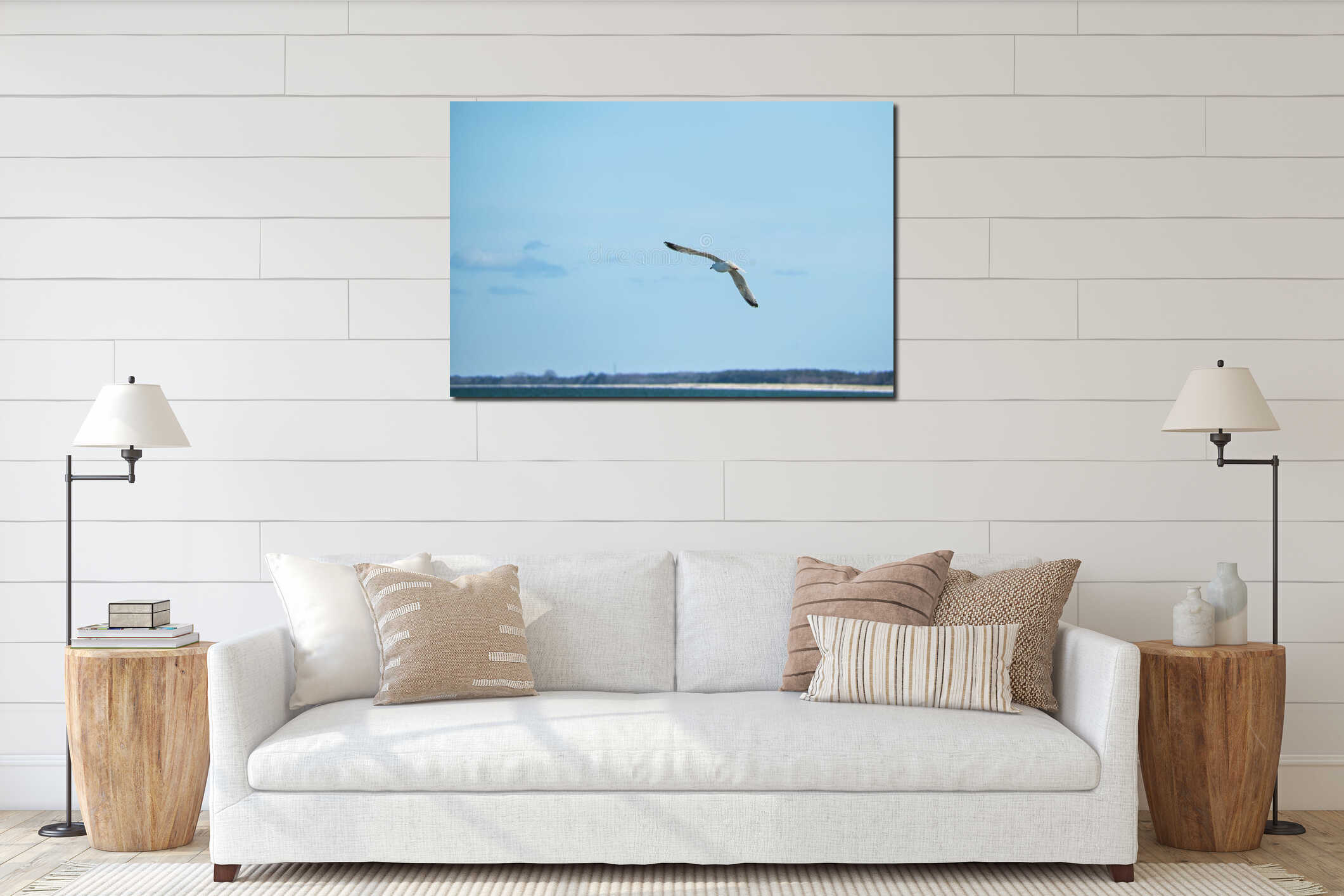 Vertical closeup shot of a seagull flying on a background of a clear blue sky interior mockup