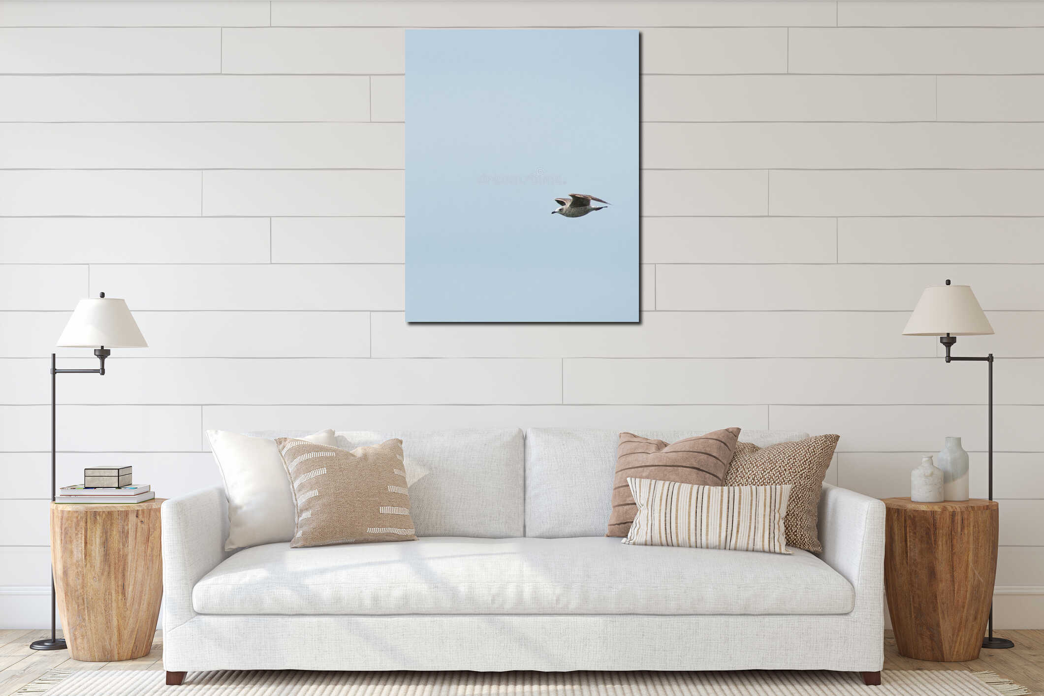 Vertical closeup shot of a seagull flying on a background of a clear light blue sky interior mockup