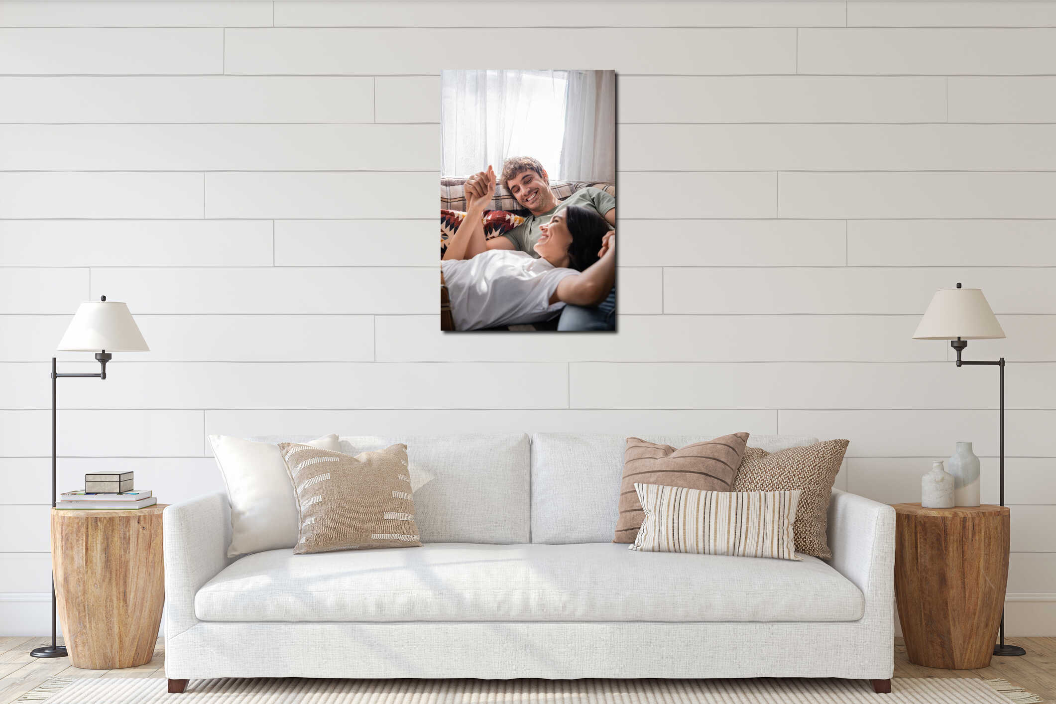 Positive couple holding hands while lying interior mockup