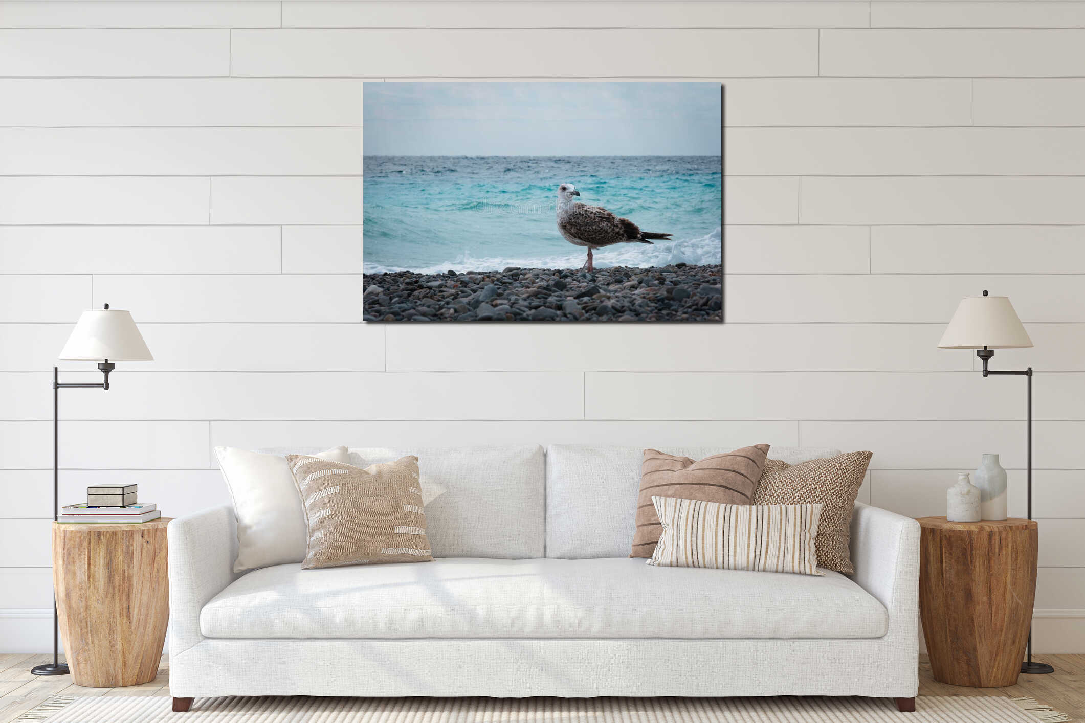 Sea gull bird in profile on a coast against blue water on the wind, silver seagull posing on a rocks on the beach. interior mockup