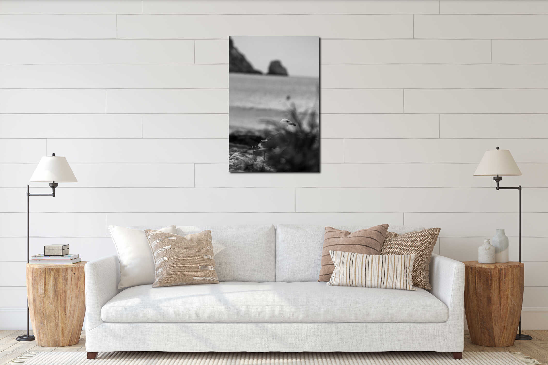 Selective focus vertical grayscale shot of a seagull at the beach interior mockup
