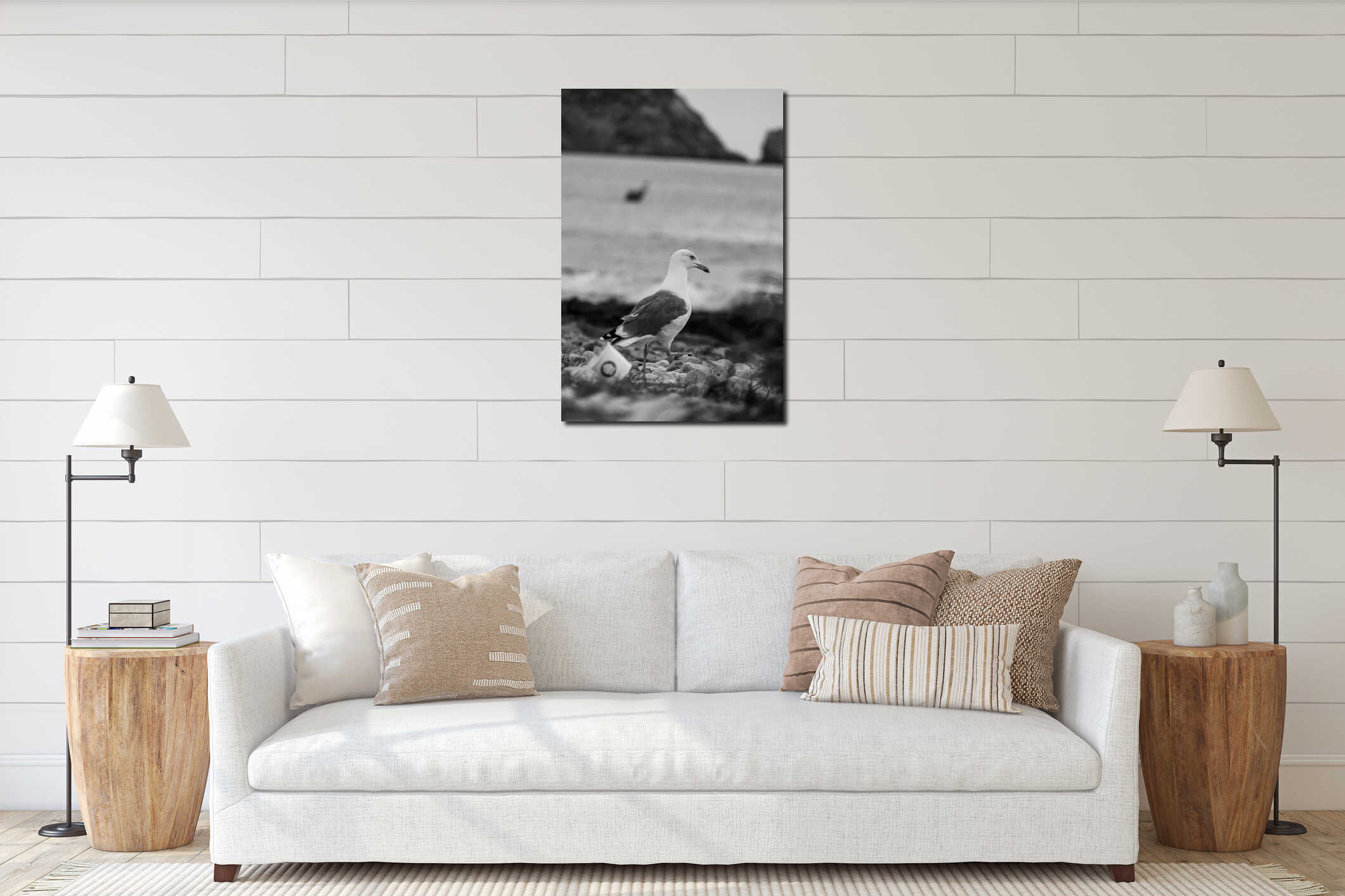 Selective focus vertical grayscale shot of a seagull at the beach interior mockup