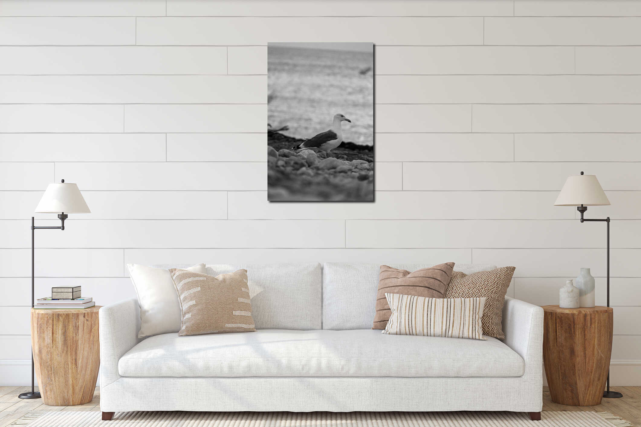 Selective focus vertical grayscale shot of a seagull at the beach interior mockup