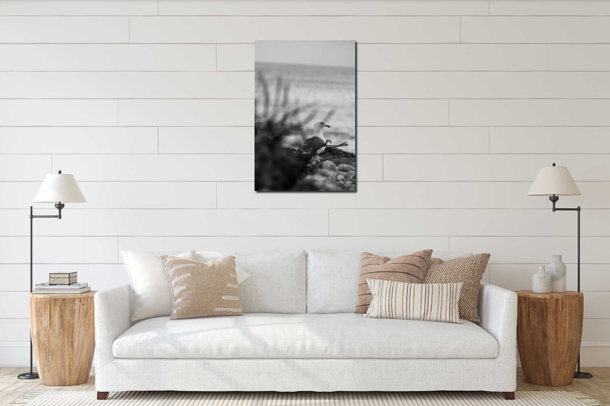 Selective focus vertical grayscale shot of a seagull at the beach interior mockup
