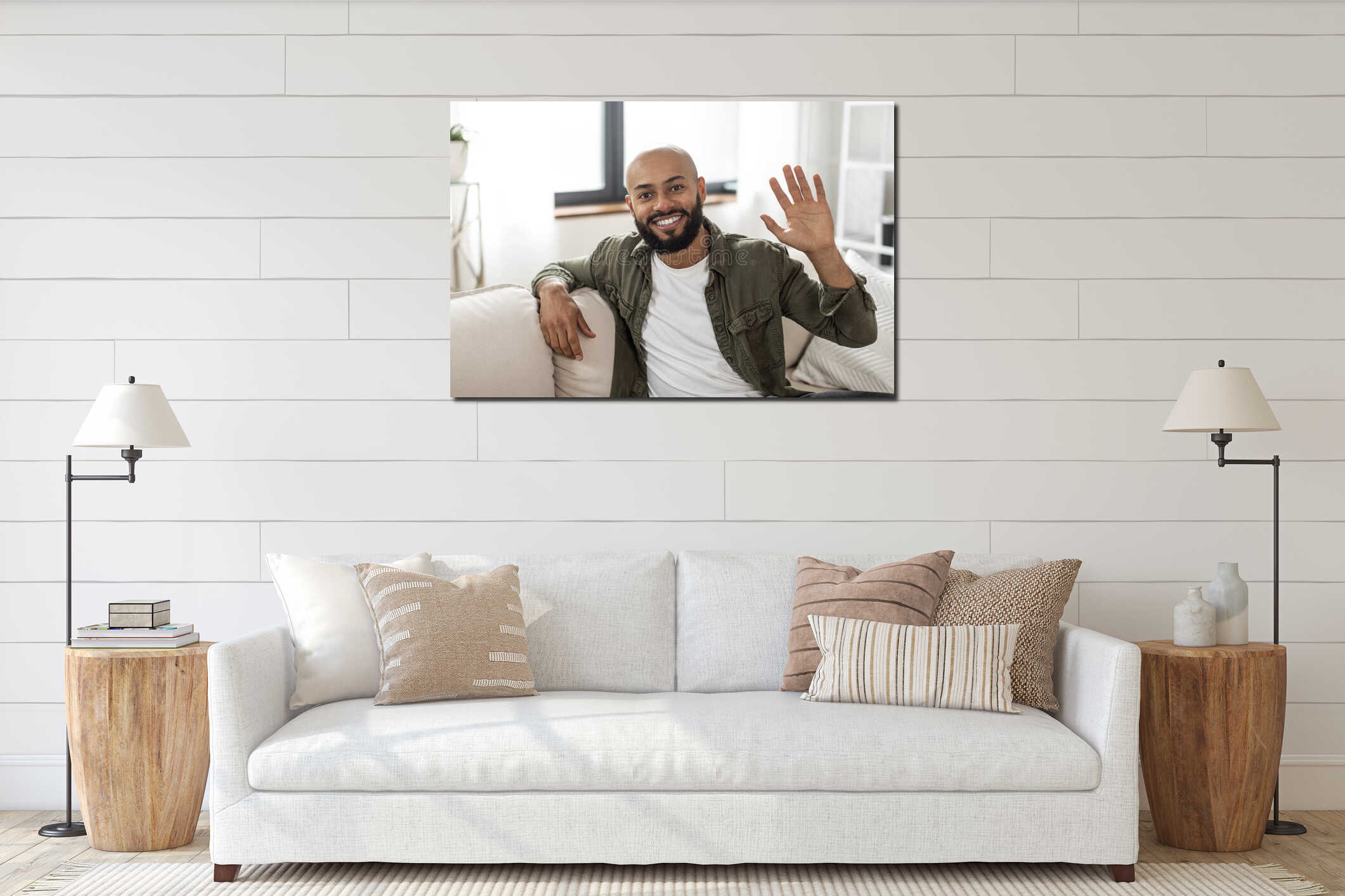 Hello. Portrait of happy mature latin man waving hand and smiling to camera, sitting on sofa at home interior mockup