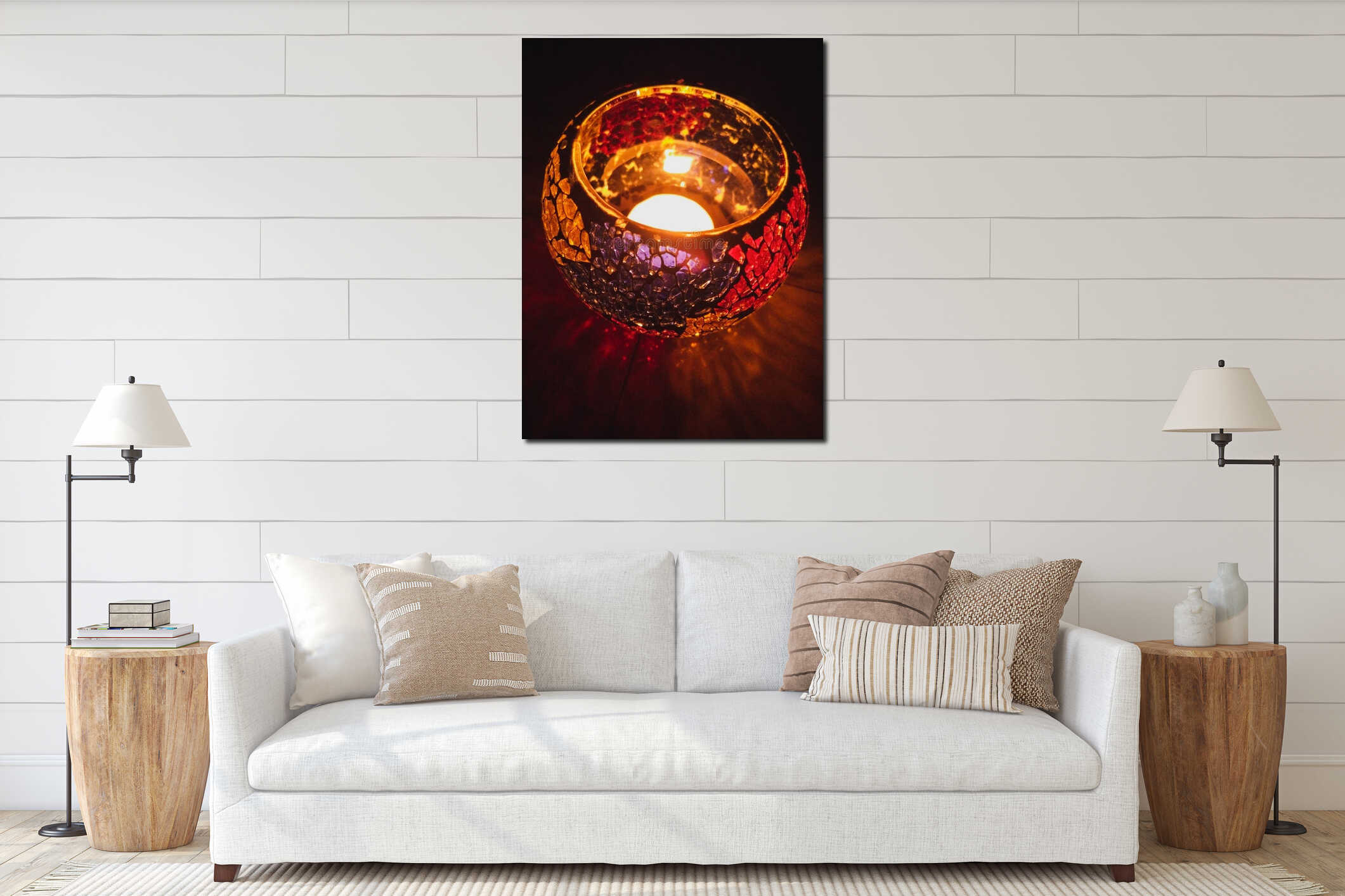 Vertical closeup of illuminated red glass mosaic candle holder on reflective surface interior mockup