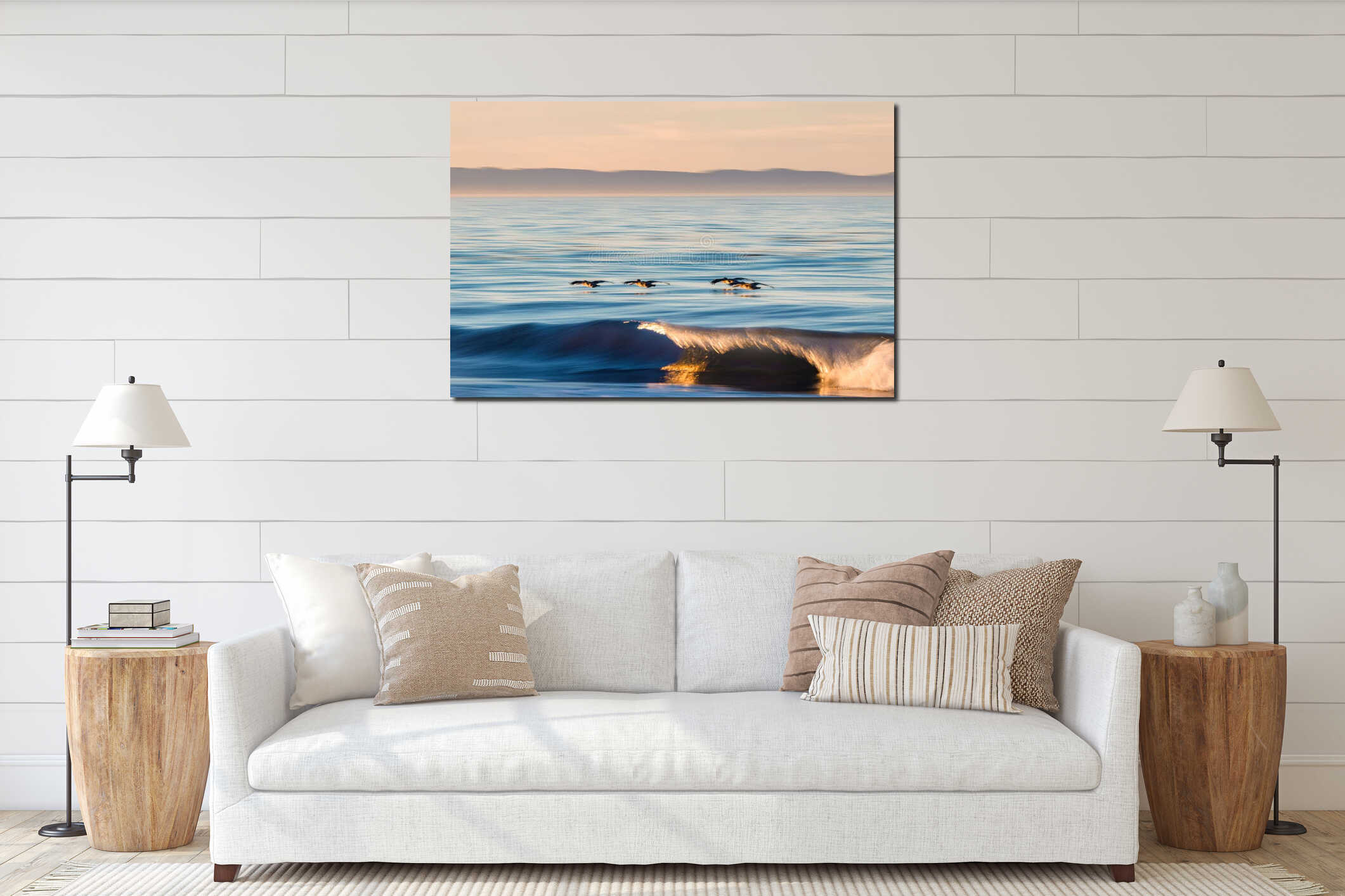 Small flock of seabirds, pelicans flying very close to the surface of a blue sea in Santa Barbara interior mockup