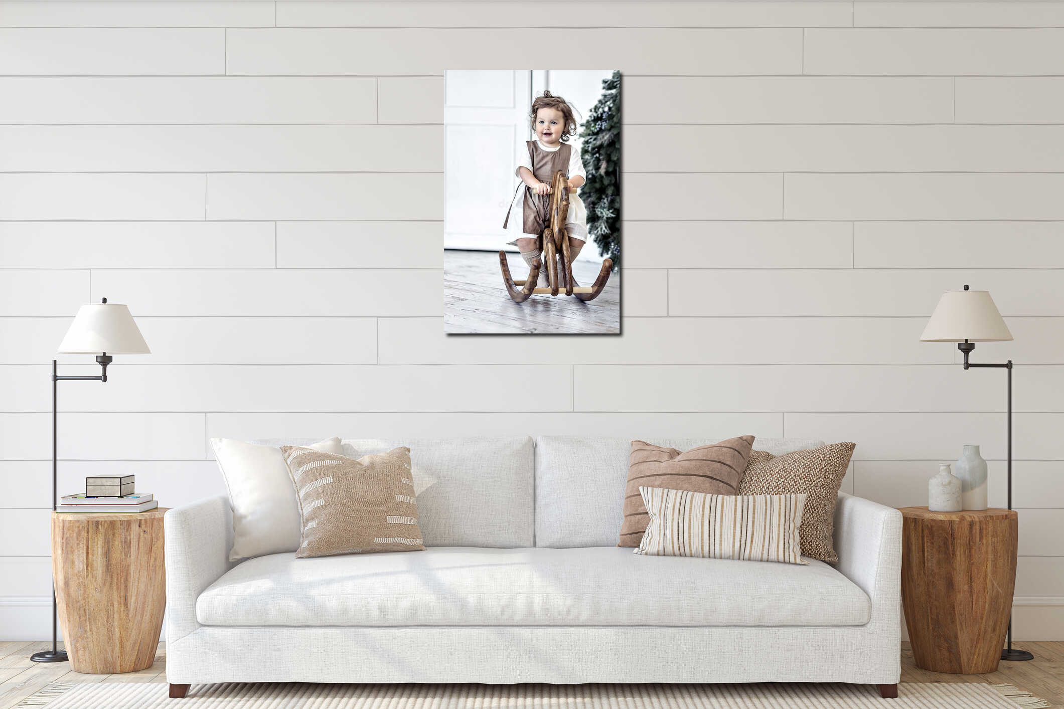 A little girl swings on a wooden horse in the room against the background of Christmas decorations interior mockup