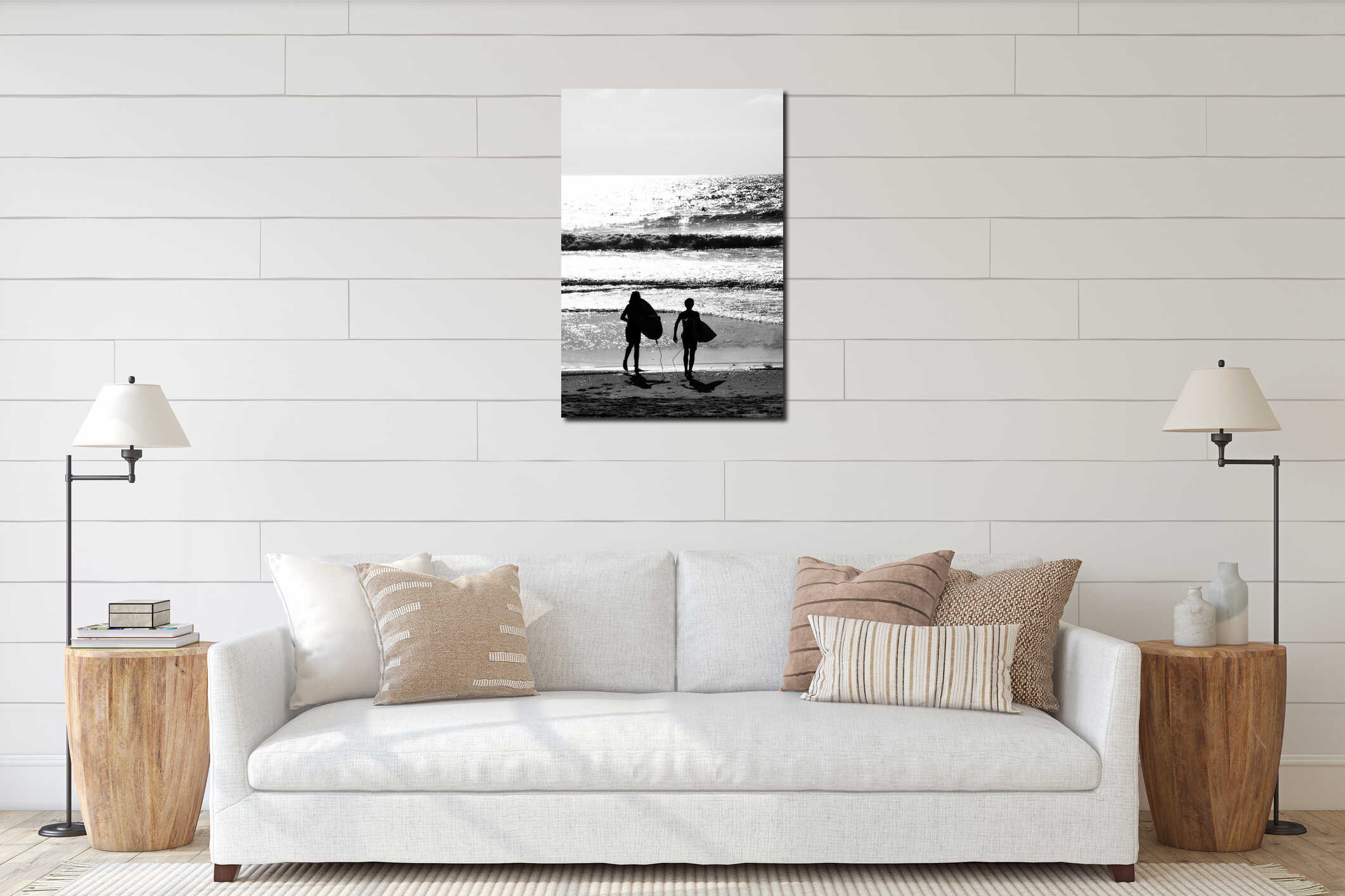 Vertical grayscale shot of a couple with surfboards walking into the sea interior mockup