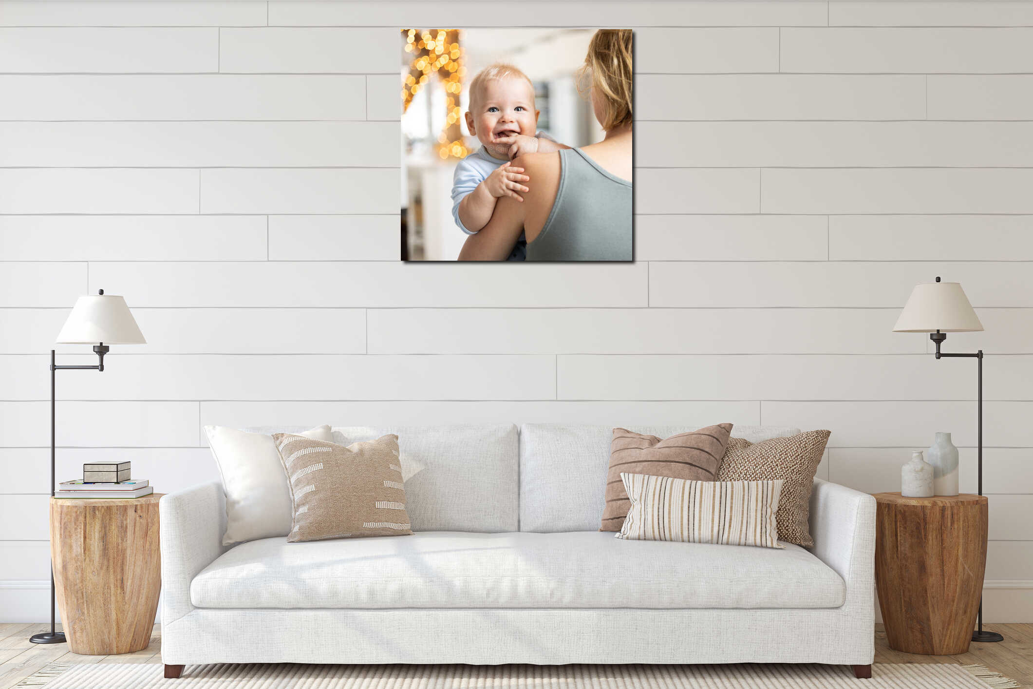 Blonde mother holding her adorable cheerful little infant baby boy. Cute infant child looking in camera and smiling at interior mockup