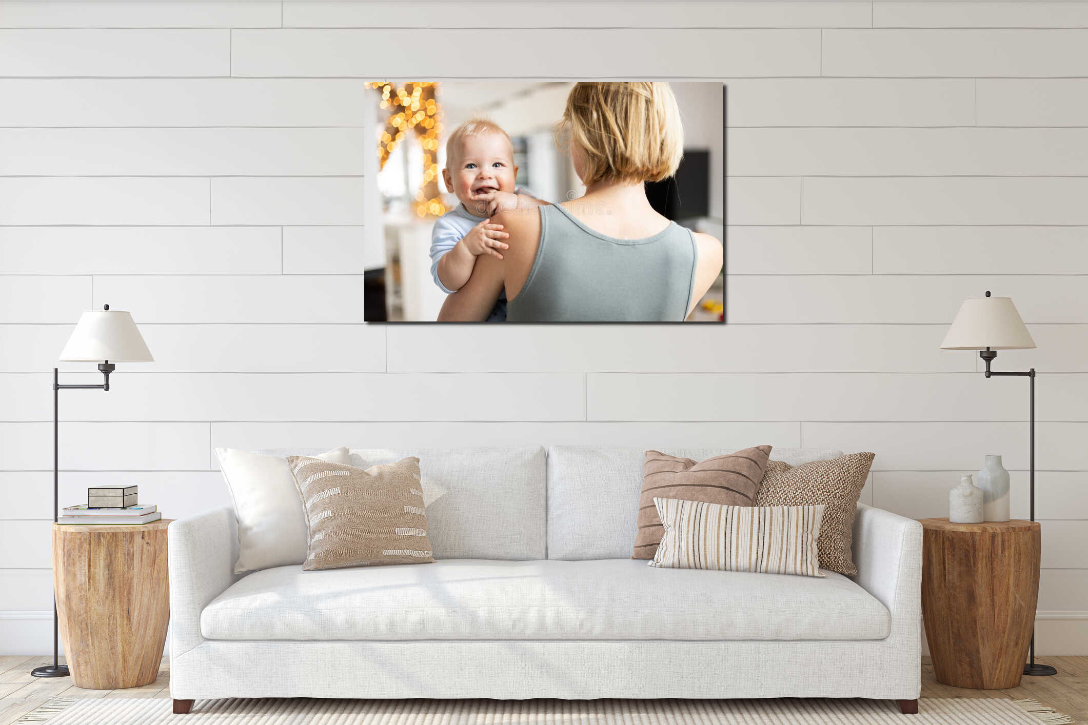 Blonde mother holding her adorable cheerful little infant baby boy. Cute infant child looking in camera and smiling at interior mockup