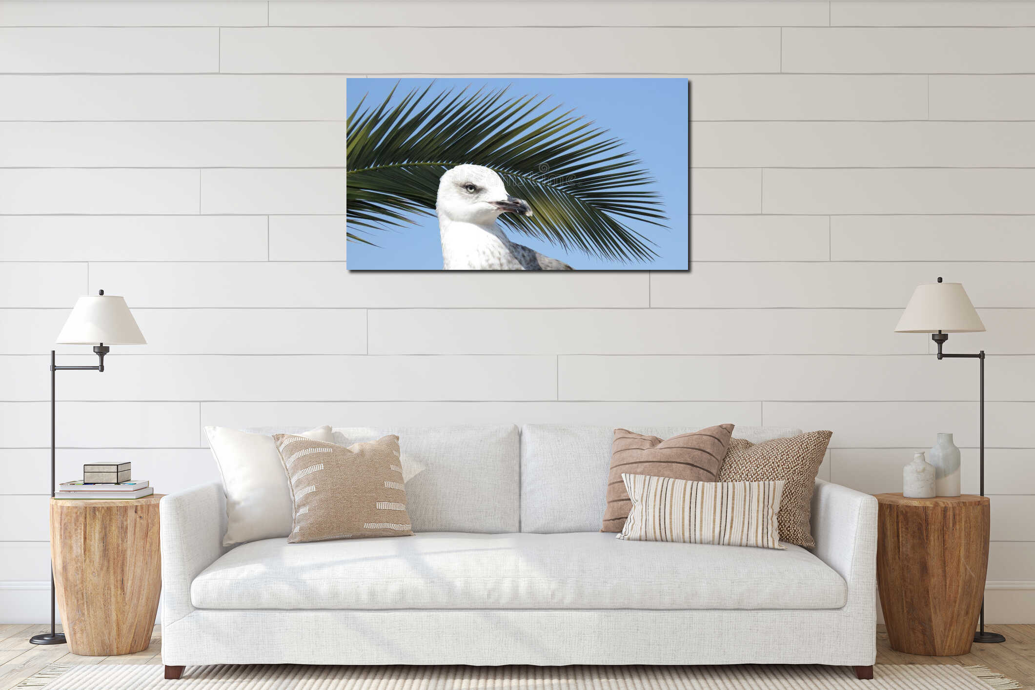White seagull standing against blue sky and green palm tree leaf. Seabird. interior mockup