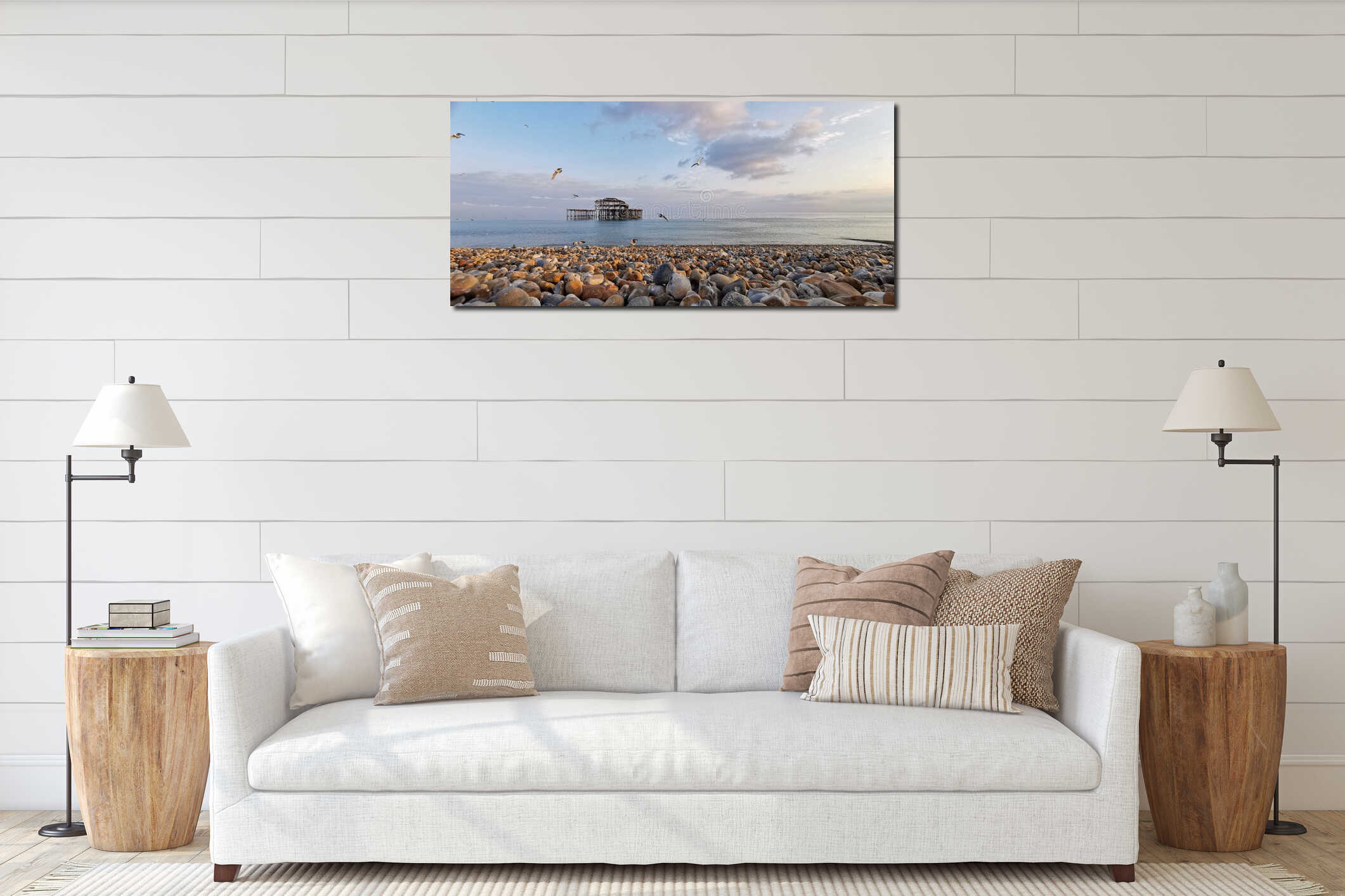 Panoramic view of a calm rocky beach with seagulls flying over it interior mockup