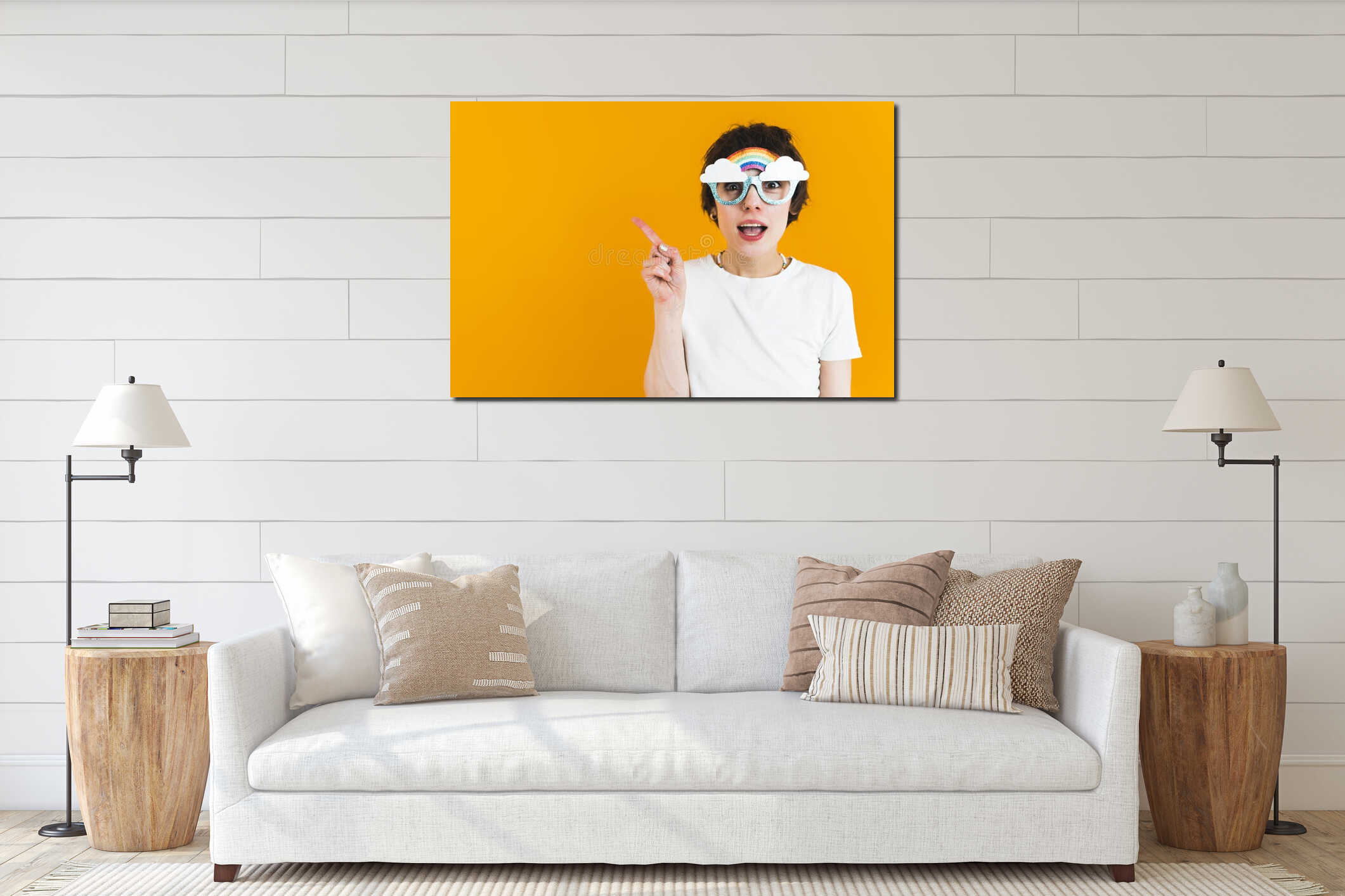 Surprised excited short-hared woman in mock-up rainbow glasses points to copy space. Studio portrait. Yellow background. interior mockup