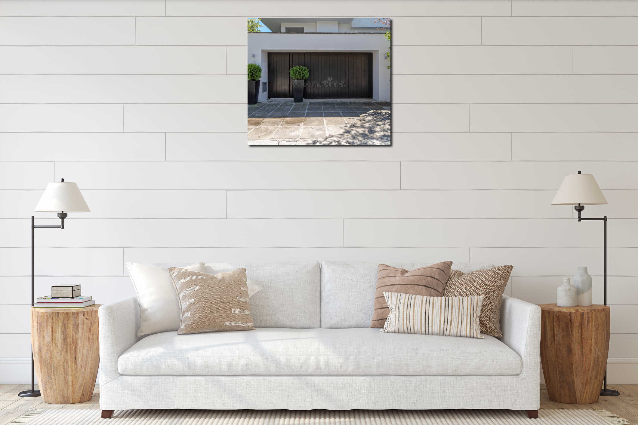 A modern family house entrance with black painted pedestrian and car doors and potted plants by the sidewalk. interior mockup