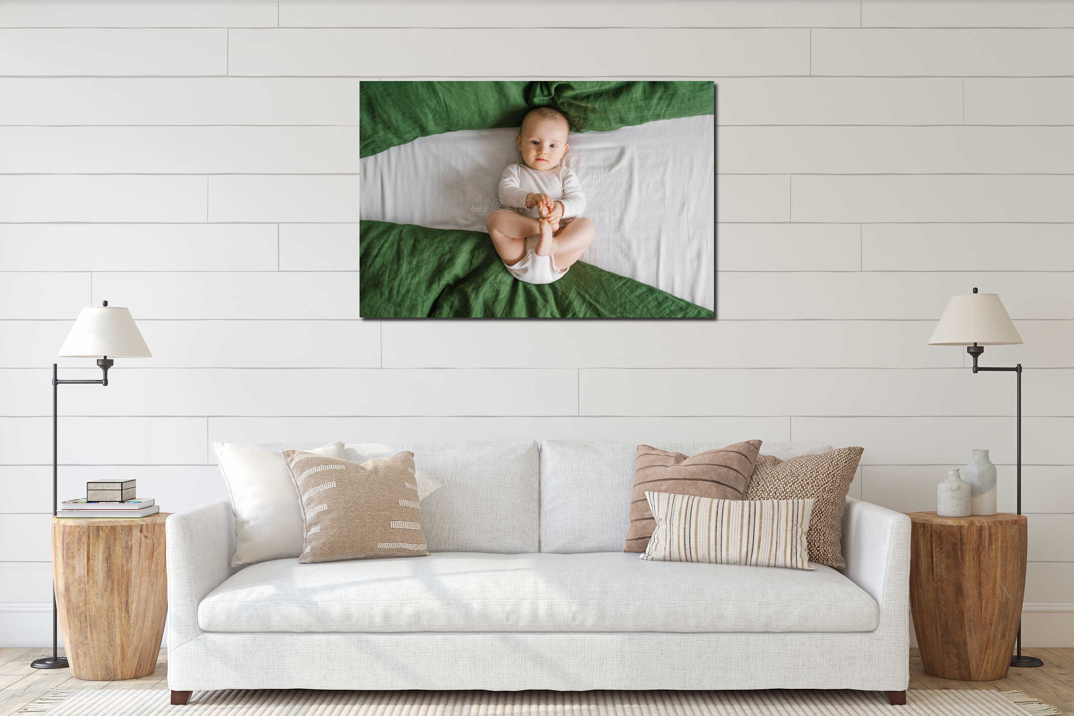 Portrait of a cute charming smiling laughing Caucasian white boy of six months old lying on a bed and looking at the camera interior mockup