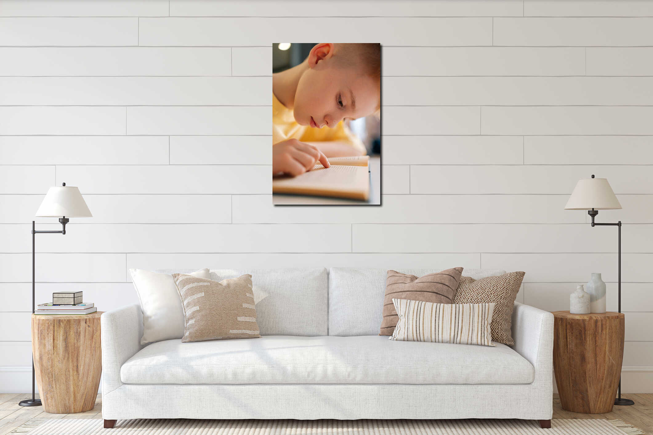 Closeup vertical shot of cute pupil schoolboy reading paper book following lines with finger along page sitting at desk interior mockup