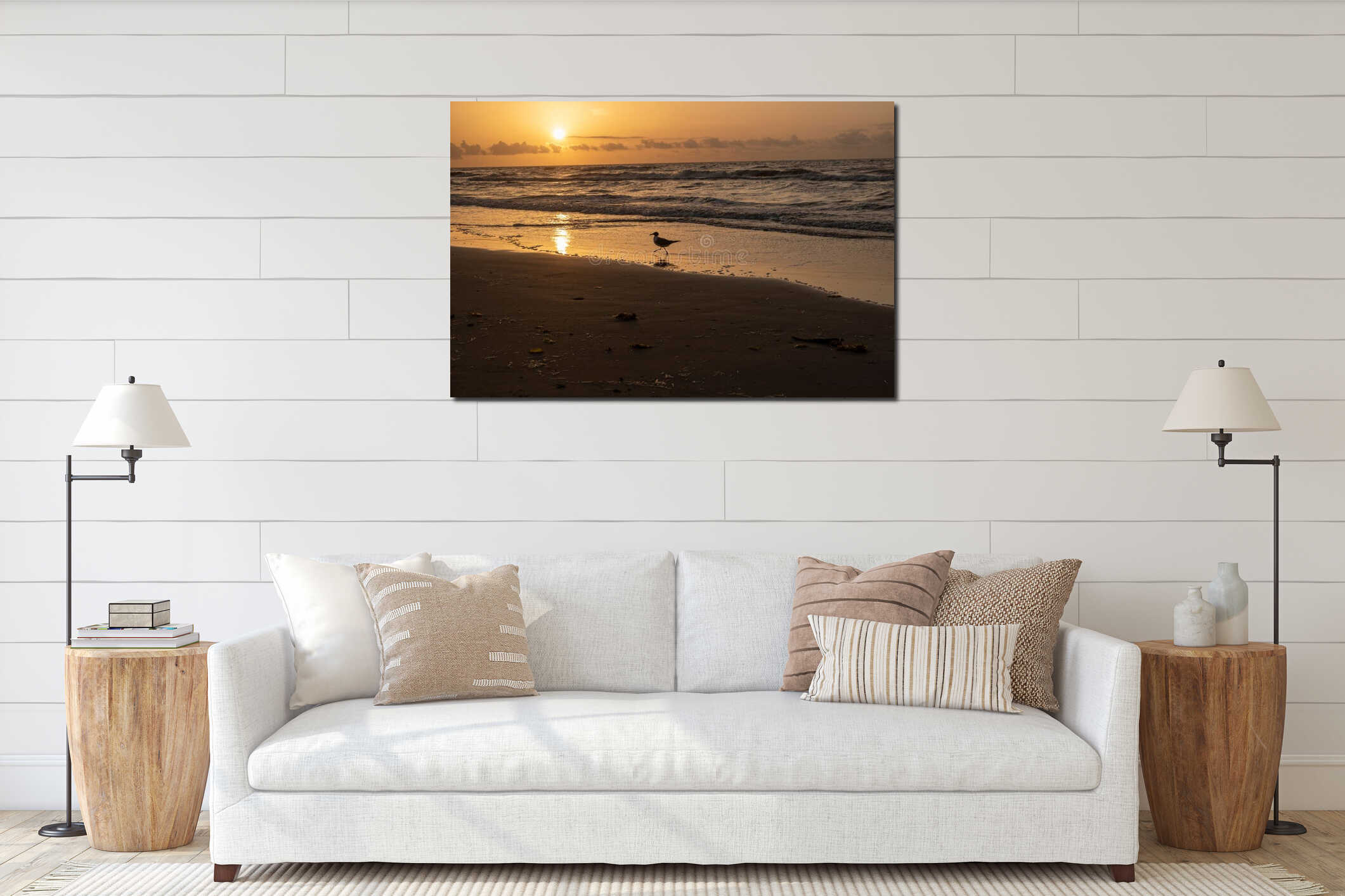 Silhouette of a seagull perched on a beach shoreline at dusk interior mockup