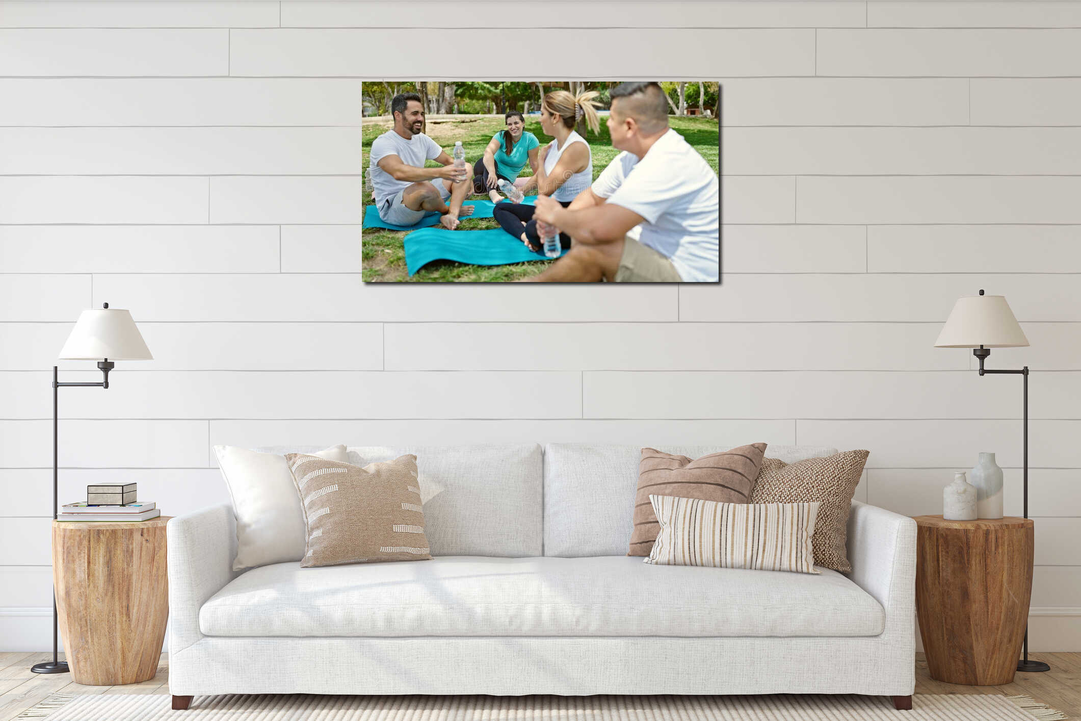 Group of people holding bottle of water sitting on yoga mat at park interior mockup