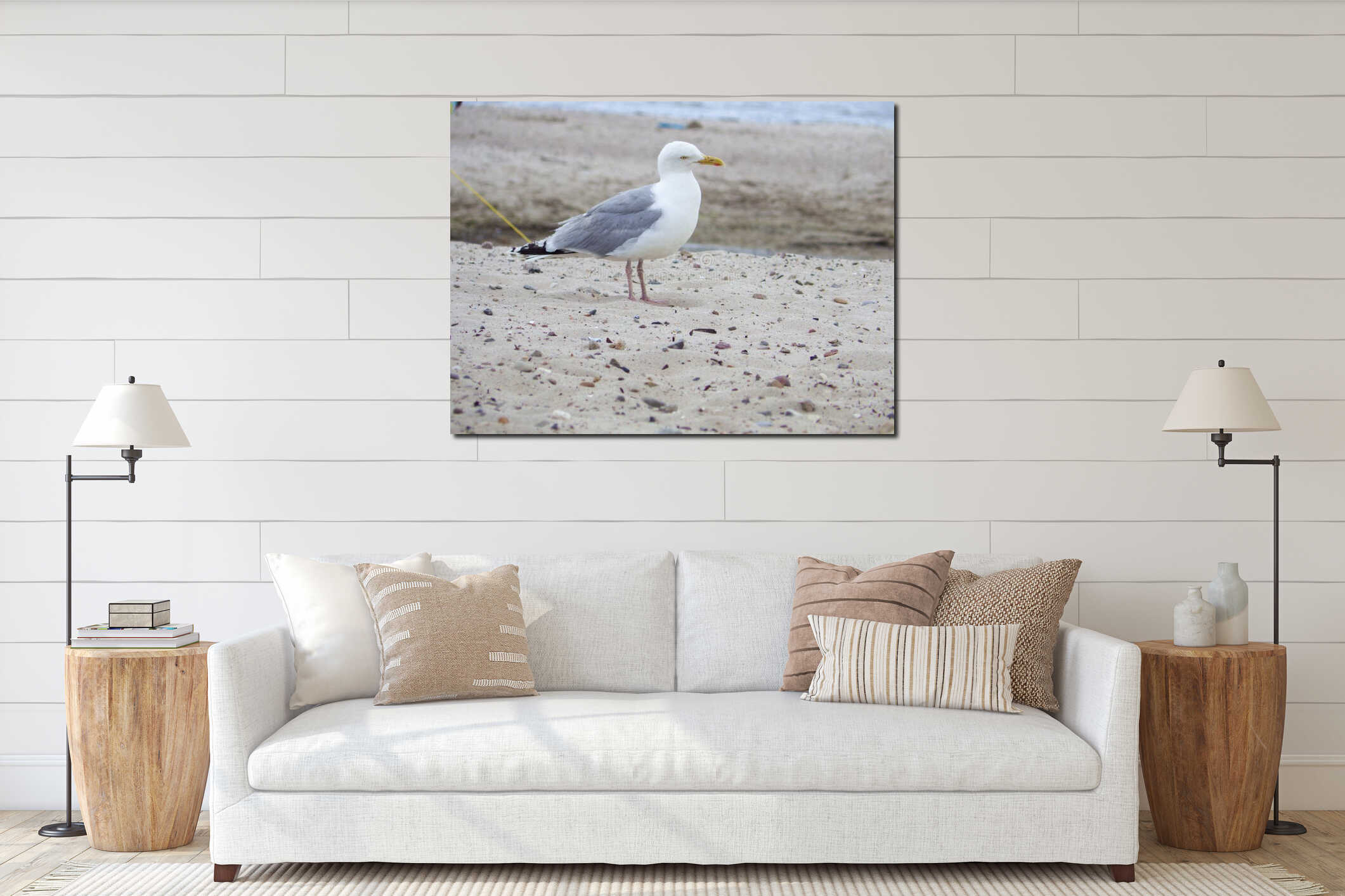 A solitary seagull gracefully perches on the sandy beach of Kiel, its wings outstretched against a backdrop of crashing waves and interior mockup