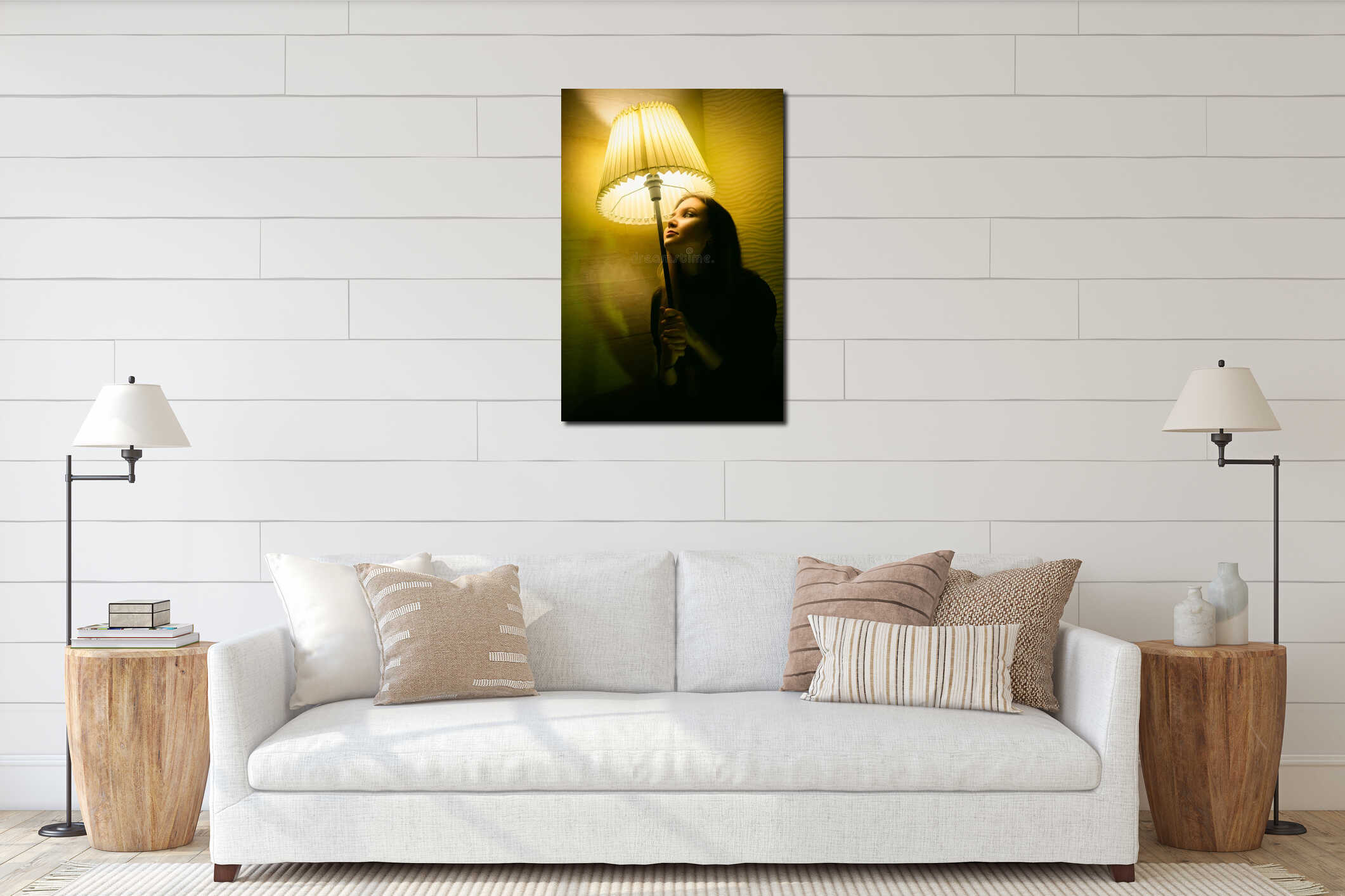 A beautiful woman in black clothes holding a floor lamp and gazing at a glowing lamp on a dark evening. Self-reflection interior mockup
