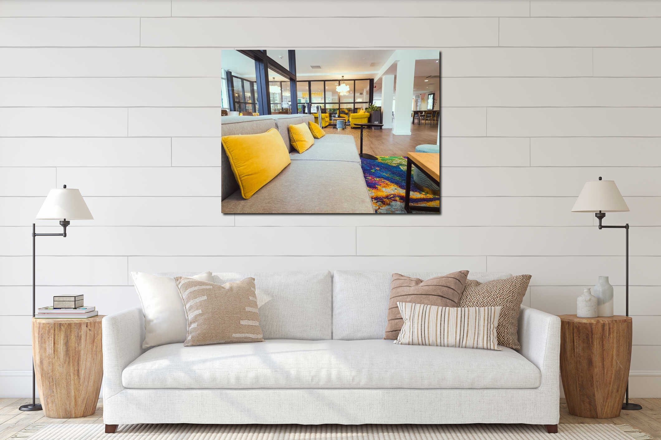 Modern lounge with grey sofa and bright orange pillow with colourful rug and wooden floor interior mockup