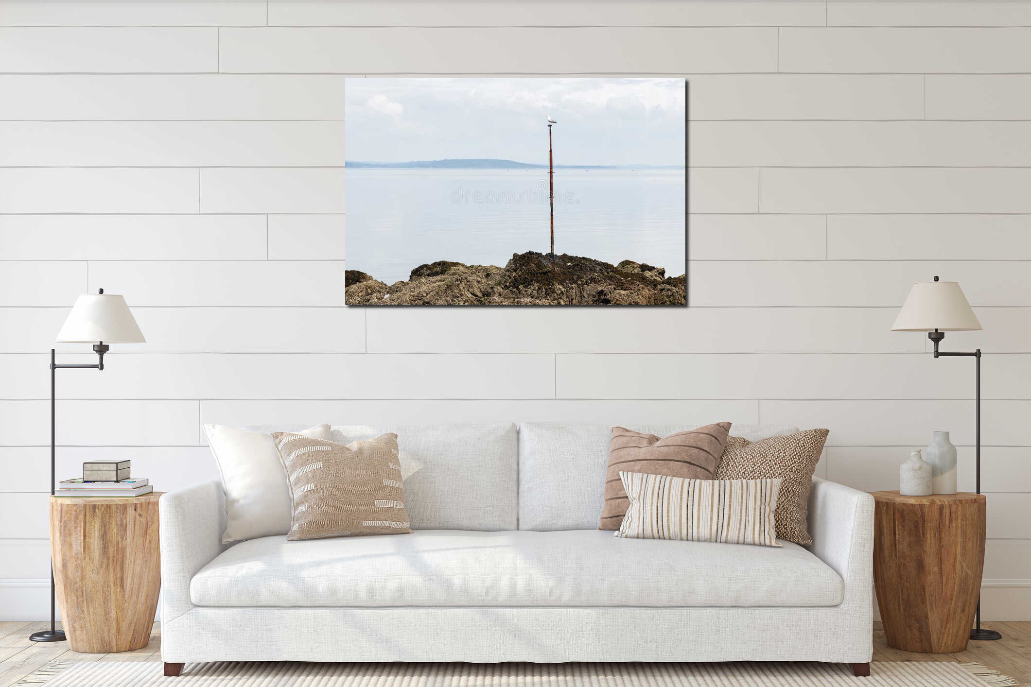 Seagull sitting on a post on the rocky coast of Crozon, Brittany, France interior mockup