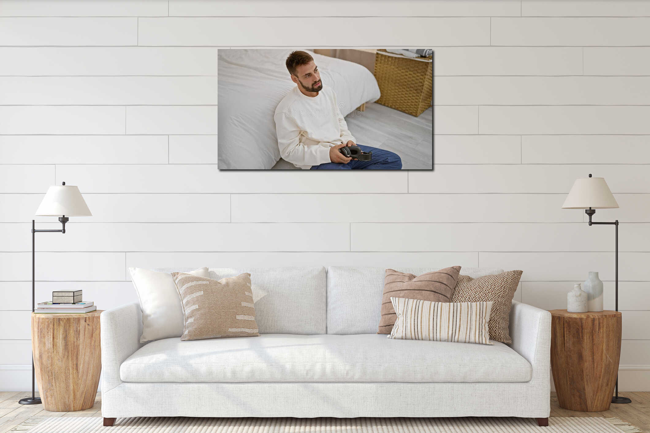 Unhappy young hispanic man, beard and headphones on, lying on bedroom floor in pjs, comfort lost, problem unfolds, music pulling interior mockup