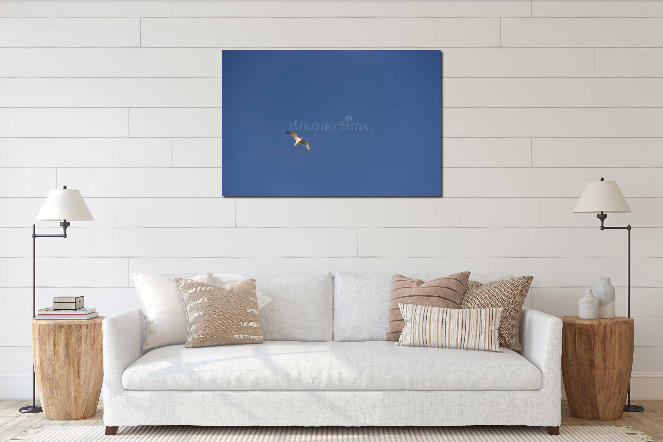 Big seagull flying in sky over mediterranean coast with warm light interior mockup