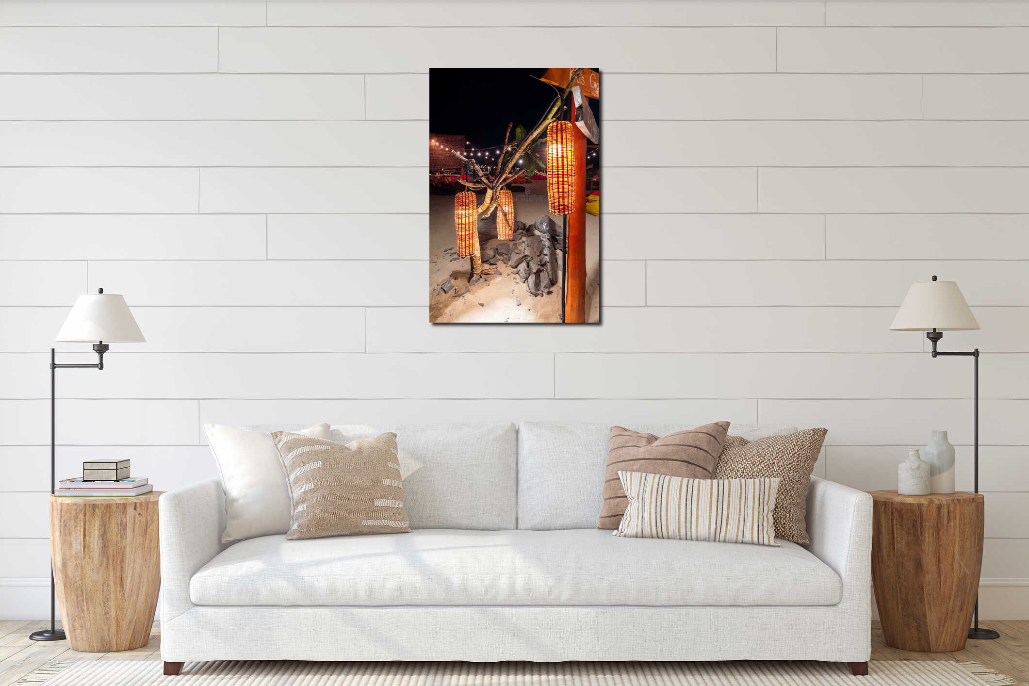 A group of bamboo lanterns are hanging from a tree, creating a warm and inviting atmosphere in a public place located on a sandy interior mockup