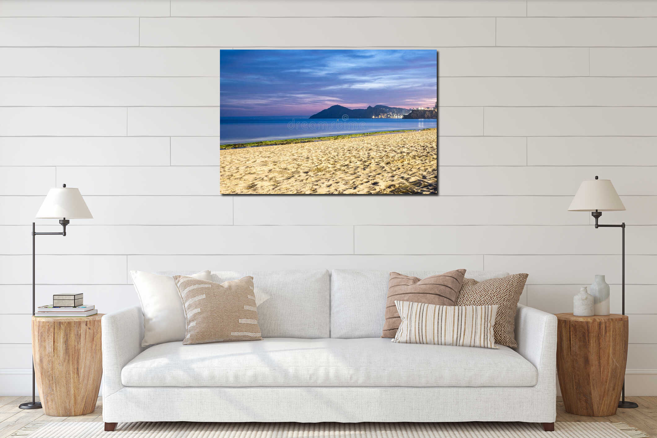 Twilight beachscape with sandy shore in foreground, calm sea, and distant hills, evoking a peaceful evening setting. interior mockup