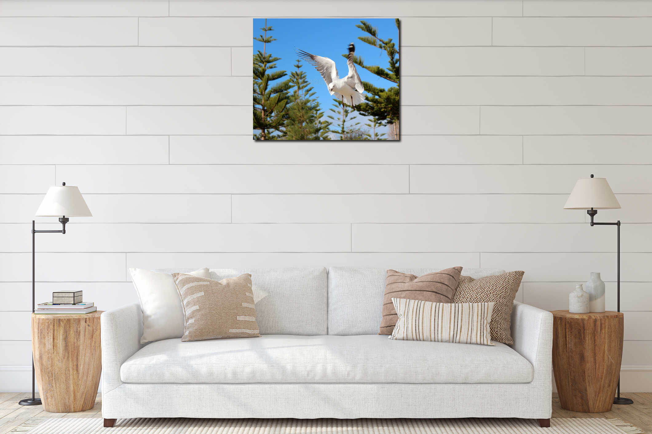 Graceful white seagull in flight against a backdrop of pine trees interior mockup