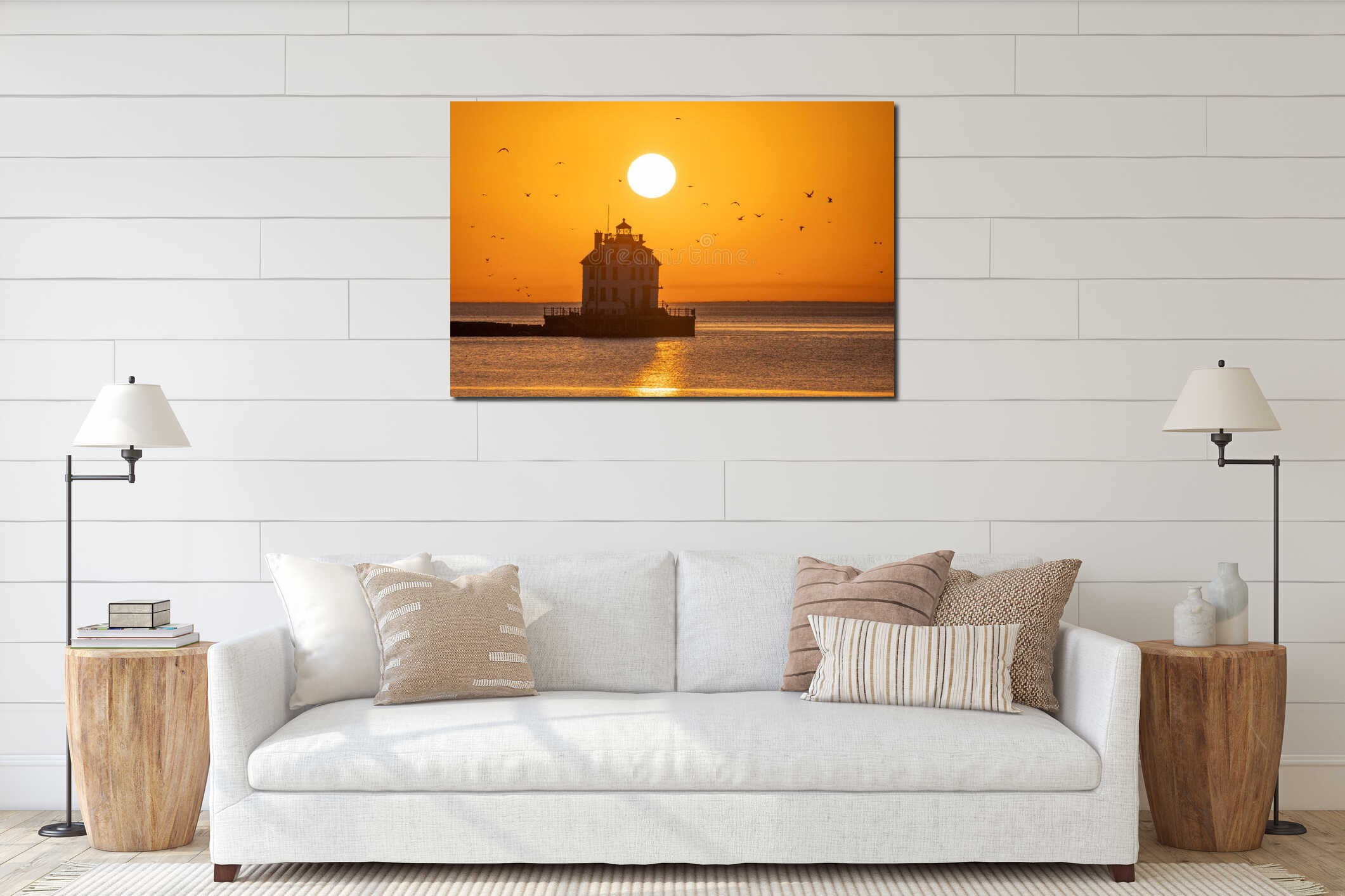 Serene lighthouse silhouette at sunset with birds flying over the calm sea. Ohio interior mockup