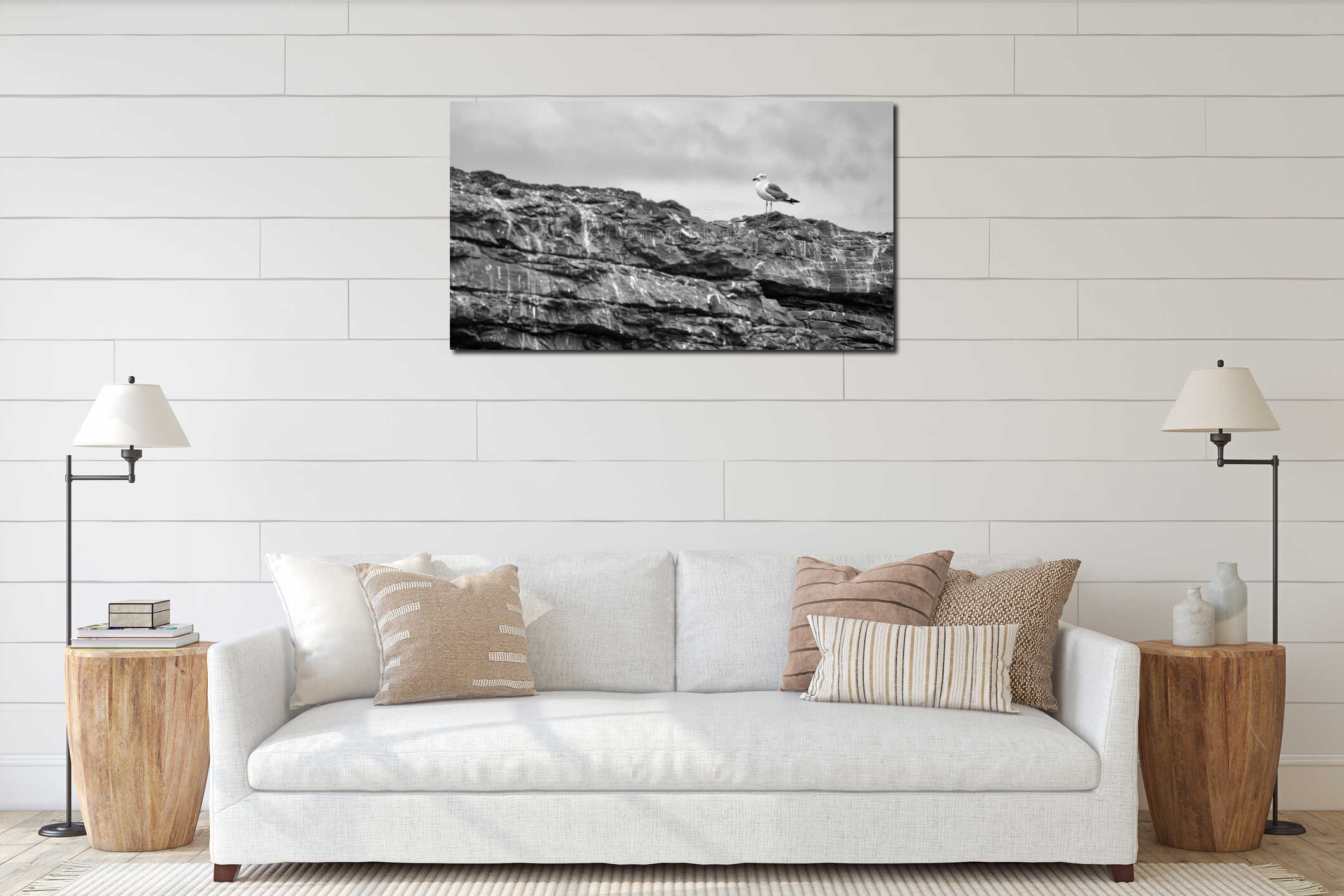 A single seagull standing alone on a desolate rocky coastline. Black and white art. interior mockup