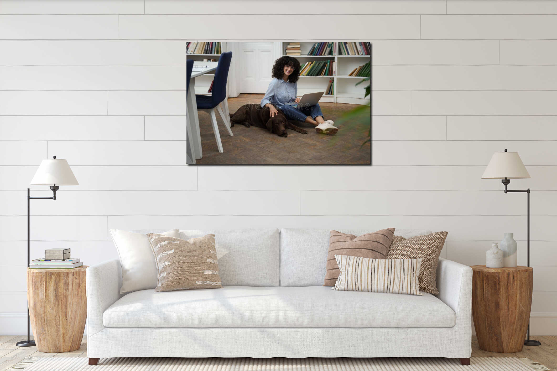 Curly-haired woman with laptop sitting on the floor, a dog next to her interior mockup