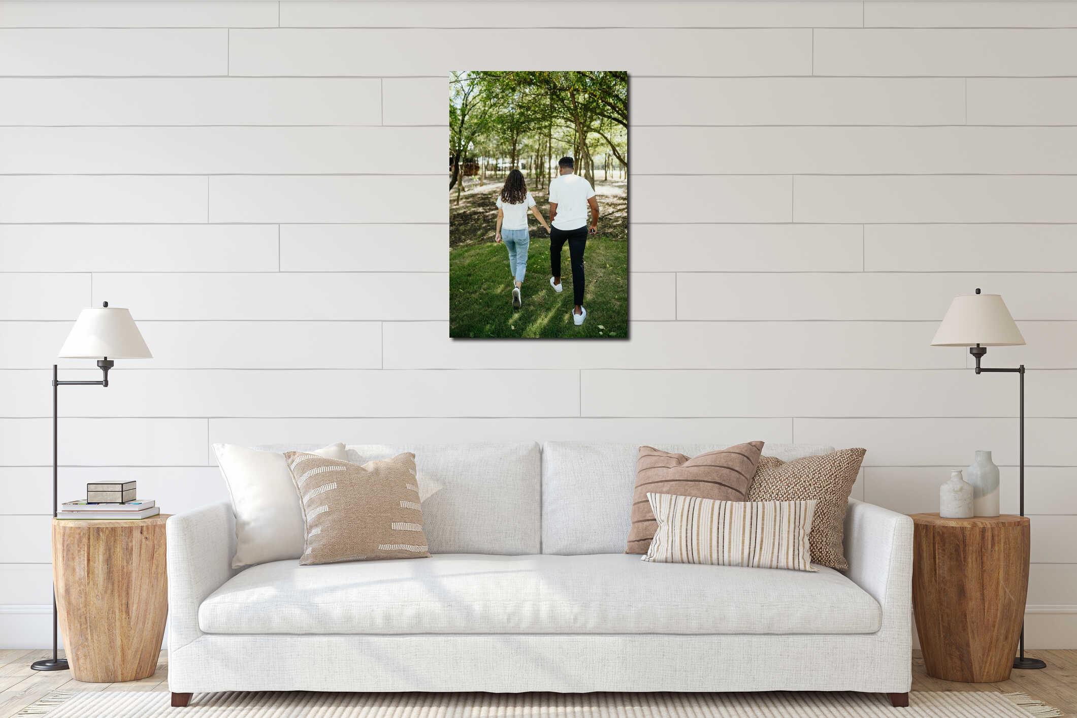 Vertical back shot of a young couple walking hand in hand through a green, sunlit forest path interior mockup