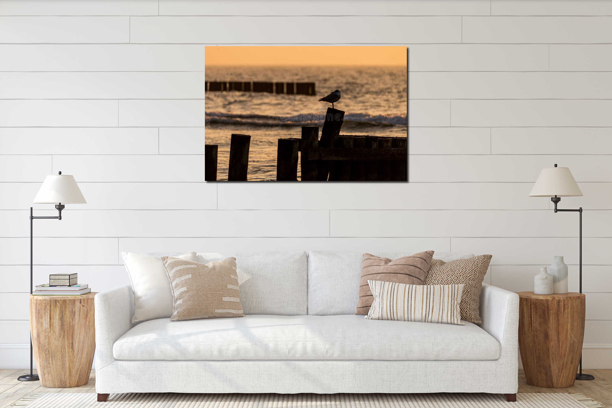 Seagull sitting on the wooden breakwater. Sunset time, Baltic Sea, Poland interior mockup